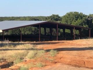 COVERED ARENA 100 x 200 EVERY HORSEMANS DREAM!!!  Ride year round in this 3 year old covered arena - no worries about the weather.  This income producing property features 8 covered barns with turnouts, 4 - 210' X 120' and 4 - 120' X 40' and established horse boarding opportunities.  The arena is well equipped with a wash bay, tack room, 5 stalls and runs.  Additional improvements include a 30 X 40 shop with overhangs on both sides for functionality. Enjoy peaceful country living in this 2018 4 bedroom 2 bath 1800 square foot mobile home with 2 living areas all situated on a hill with scenic views overlooking the arena and a beautiful wooded area where the deer and turkey run freely.  All these great amenities and is close to the metroplex and NRS.  Come take a look  You don't want to let this one get by. Gravel road driveway to be installed when weather permits.  New Aerobic Septic system being installed.