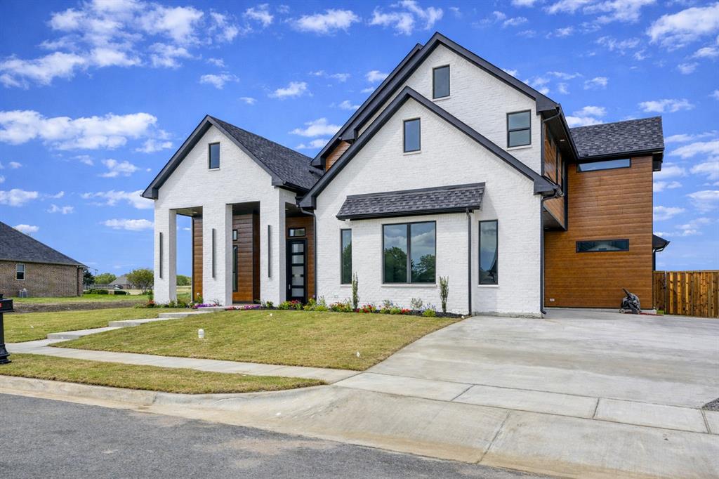 Builder is now offering up to $25,000 in seller concessions that may be used toward closing costs and-or an interest rate buy down, creating an incredible opportunity for buyers to lower monthly payments and maximize affordability. Located in prestigious Fountain Creek Estates, this newly constructed 2 story home offers a bright, open design with abundant natural light and thoughtfully selected finishes throughout. Expansive 7-foot windows, 10-foot ceilings with dramatic 14-foot accents, & beautifully trimmed ceilings create a spacious and refined atmosphere from the moment you enter.
The kitchen and living spaces are designed for both everyday living and entertaining, featuring 10-ft custom cabinetry, a gas cooktop, large island, walk-in pantry, built-in dry bar, & a sleek electric fireplace anchoring the main living area. A private office & game room provide flexible spaces for work, relaxation, or hosting guests.

The primary suite offers a relaxing retreat with spa-inspired finishes including a separate shower and soaking tub, dual vanities, and a custom primary closet. A spacious utility room connected to the primary closet adds everyday convenience. The home offers 4 bedrooms and 3.5 bathrooms, including a main-level guest suite, providing privacy and comfort for family and visitors.

Beautiful porcelain tile & engineered wood flooring add durability and style, while foam spray insulation enhances energy efficiency and year-round comfort.

Step outside to a covered patio and an incredible backyard view that stretches across open land for miles, offering a peaceful setting and wide-open Texas skies rarely found in neighborhood living. Combined with a side-entry two-car garage and fresh landscaping, the home delivers strong curb appeal and a timeless yet contemporary design.

A standout new construction opportunity in one of Pottsboro’s most desirable communities, just minutes from Lake Texoma, Pottsboro ISD, dining, marinas, and everyday conveniences.