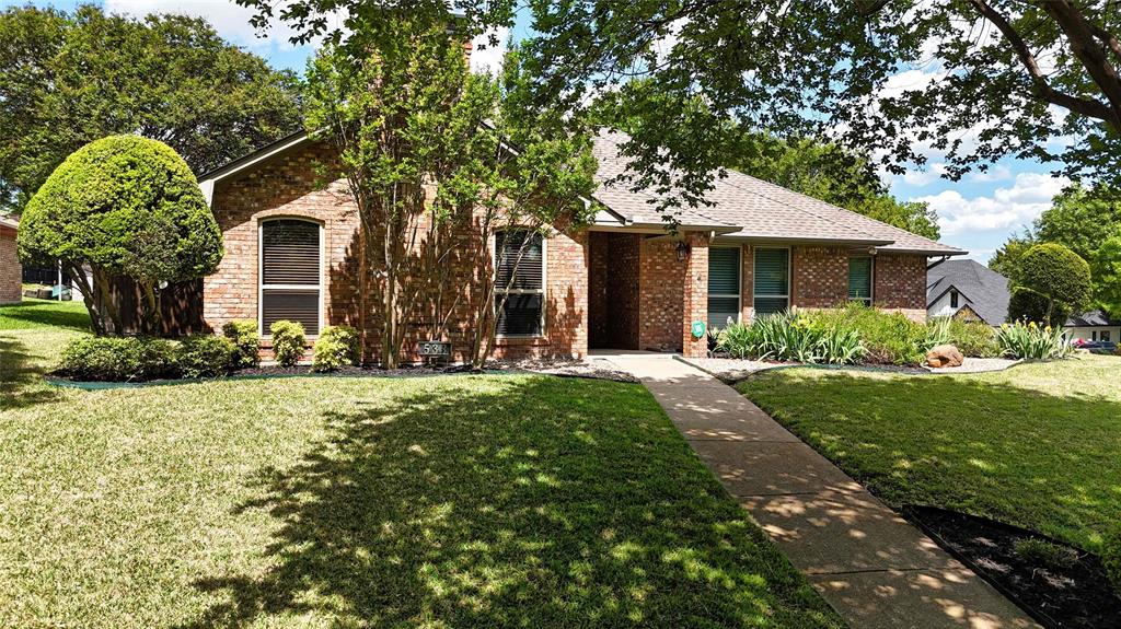 Situated on a large corner lot in the established, tree-filled neighborhood of Hidden Canyon, this beautifully maintained single-story home offers a versatile floor plan designed for comfortable living & entertaining. Featuring 3 spacious living areas, the front living room welcomes you with a striking brick fireplace with gas logs, elegant trayed ceiling & abundant windows overlooking the landscaped front yard. The 2nd living area, located at the rear of the home, is ideal as a game room, media room, or hobby space & includes a large storage closet along with a convenient half bath. The 3rd living space is a bright sunroom just off the kitchen, offering direct access to the backyard, garage, and breakfast nook, making it perfect for relaxing, working, or enjoying morning coffee. The generously sized primary suite is privately situated in its own wing and features an ensuite bath with dual vanities, a walk-in shower, a large soaking tub, and two walk-in closets. Two additional guest bedrooms are located on the opposite side of the home and share a well-appointed full bathroom, providing privacy and functionality for family or guests. The kitchen was thoughtfully remodeled in 2016 with granite countertops, updated backsplash, painted cabinetry, modern appliances, stylish lighting, and includes a new faucet and disposal installed in 2025, plus a gas line is available if a gas cooktop is preferred. Both the formal dining room and breakfast nook provide convenient access to the kitchen, ideal for everyday meals or entertaining. Major system updates include a variable speed HVAC system installed in 2016 with a new condenser in 2025, a whole house air filtration system added in 2024, energy-efficient windows installed in 2019, Class 4 impact-resistant roof installed in 2019. Water Saving Irrigation System! The home also includes a two-car garage and is conveniently located near the scenic Roy Orr walking and biking trail, known for its beautiful trees and creek setting.