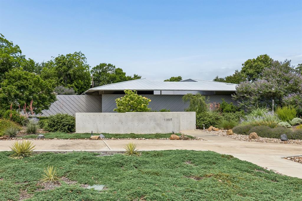 Tucked next to the Dallas Athletic Club, this modern residence offers a rare balance of privacy, craftsmanship, and understated luxury. Designed by Smitharc Architecture & Interiors, this 2019 home encloses a central courtyard—a Zen-inspired private garden that soothes and delivers natural light throughout the home.

The large .48-acre lot features over $300,000 in curated landscaping—mature trees, layered gardens, stone pathways—with drip irrigation and a dedicated water meter. Nature achieves the effect of complete seclusion and uninterrupted calm.

The 4-bedroom, 2-bath residence is suffused with natural light from 9 skylights. The living room has floor-to-ceiling windows and is anchored by a statement Montigo gas fireplace. The kitchen—designed for serious use—features a 5-burner gas cooktop, dual electric ovens, commercial-grade ventilation, and organic veined granite surfaces that extend across counters and high backsplashes. The dining area, framed by a russet accent wall and views onto the courtyard, has Tech lighting and Gallery System artwork framing rails.

Engineered for enduring performance, the home is built on a Tella Firma foundation system specifically designed for Texas soil conditions. Light control is achieved with motorized blackout shades by The Shade Store, a remote-controlled patio awning, and courtyard screen. Dual HVAC zones ensure climate precision, while CAT 6 wiring, fiber optic connection, sound-shielded plumbing, hardwired cameras, DSC security, and keypad entry deliver seamless modern functionality.

Enclosed by 9-foot privacy walls, this is a residence designed for those who value privacy, quality, and architectural integrity.