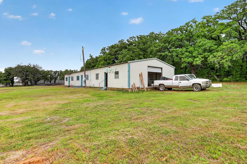 Multiple Flex property opportunity!! Rare 18.29 acres in Burleson with a 3100 sq ft home! This home is situated towards the back of the property and features an electric gate which makes it more private. Upon entry you will find a very large living area complete with wood burning fireplace and plenty of room for everyone! Kitchen is large and features a breakfast area with large bank of windows. Breakfast bar, built ins, & such a great space to prepare meals! The primary features 2 full baths and is very large both with walk in showers and one bath has a giant walk in closet. Each secondary bedroom has its own bath. Office by front entry is perfect for paying bills or working from home! The acreage is heavily treed and an additional 2700 sq ft building for storage or workshop and has electricity! This home has so much potential and it faces FM 731 so there is possibility portions could be rezoned commercial!