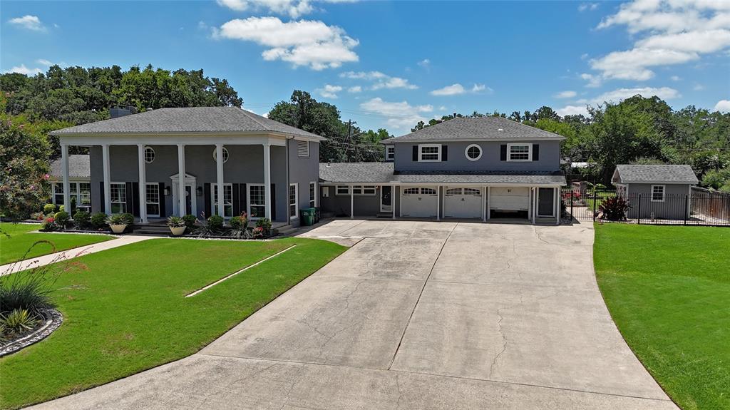 Stunning colonial-style estate situated on nearly one acre in a highly sought-after North Denton location. Enjoy the perfect blend of privacy and convenience, just minutes from TWU, UNT, Denton's vibrant Downtown Square, endless dining and entertainment options, and major highways. A meticulously landscaped lawn and expansive columned front porch create a timeless first impression. Inside, this completely updated home showcases exceptional craftsmanship with extensive molding and trim work, beamed ceilings, original hardwood floors, and an abundance of natural light throughout. The sprawling floor plan offers two oversized bedrooms, each with the potential to serve as a primary suite, along with beautifully updated full baths. A charming sunroom retreat off the primary bedroom overlooks the backyard, providing the perfect place to relax and unwind. At the heart of the home, the designer kitchen features JennAir appliances, including double ovens and an electric cooktop, quartz countertops, a large island with breakfast bar seating, built-in wine refrigerator, and abundant storage space—ideal for both everyday living and entertaining. The property also includes a three-car garage with a private side entrance leading to a fully equipped apartment above, complete with a living area, full kitchen, bedroom, and full bath, offering excellent flexibility for guests, extended family, or rental income potential. Step outside to your own backyard oasis featuring an expansive covered patio, sparkling swimming pool, mature shade trees, and two storage sheds. This extraordinary property offers historic charm, modern updates, and unmatched versatility in the heart of Denton.