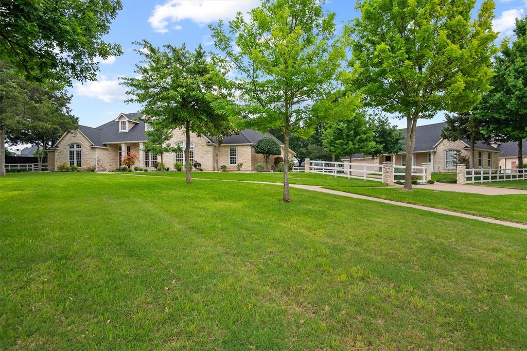 One of the most stunning properties in the highly sought-after Somerset subdivision, this exceptional estate offers space, versatility, and timeless appeal, all set on spacious and beautifully landscaped grounds.
The main residence spans 4,058 square feet and is thoughtfully designed for both everyday living and memorable entertaining. Featuring 4 bedrooms, 3 bathrooms, and a private office, the home showcases tall ceilings, beautiful trim work, and an inviting layout with multiple gathering spaces. The expansive kitchen truly serves as the heart of the home, seamlessly connecting to the breakfast nook, large dining room, family room, and a light-filled sunroom—creating the perfect setting for hosting or relaxing with family and friends. Abundant natural light fills the home throughout, enhancing its warm and welcoming atmosphere. A 3-car garage adds convenience and functionality. The detached guest house offers an additional 933 square feet of comfortable living space, complete with 2 bedrooms, 1 bathroom, eat-in kitchen, and a living room, along with its own 2-car garage—ideal for multi-generational living, guests, or potential rental opportunities. NEW UPDATES include fresh neutral paint and new carpet in the main house.  Both the main home and guest house feature new roofs installed in April 2026, providing peace of mind and added value for the next owner.  With its combination of elegant design, flexible living spaces, and inviting outdoor areas, this Somerset property truly stands out as a rare opportunity to own a showpiece home in one of the area’s most desirable neighborhoods. Midlothian retains its small-town charm while offering convenient access to restaurants, shopping, award-winning schools, as well as the Methodist Midlothian Medical Center.