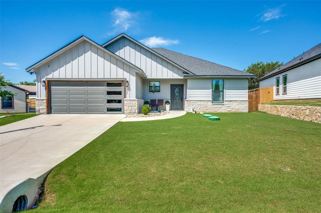 Welcome to this beautifully appointed home nestled in a desirable gated community just minutes from Lake Granbury. Designed with an open-concept layout, this home offers a seamless flow between the living, dining, and kitchen areas—perfect for both everyday living and entertaining. The inviting living room features an electric fireplace while wood-look tile flooring extends throughout the home -- no carpet anywhere. The spacious kitchen is complete with a large island with seating, stainless steel appliances, ample soft-close cabinetry, and a pantry for added storage. The primary suite provides a relaxing retreat with an ensuite bath featuring dual sinks, a huge walk-in shower, and generous closet space. Two additional bedrooms offer flexibility for family, guests, or a home office. Step outside to enjoy the large covered patio overlooking a private backyard—an ideal setting for morning coffee, outdoor dining, or simply unwinding at the end of the day. Residents enjoy access to an exceptional array of community amenities, including a clubhouse, fishing pier, boat ramps, swimming pools, playground, sandy beach, and sports courts, providing endless opportunities for recreation and relaxation. This is more than a home—it's a lifestyle. Schedule your showing today!
