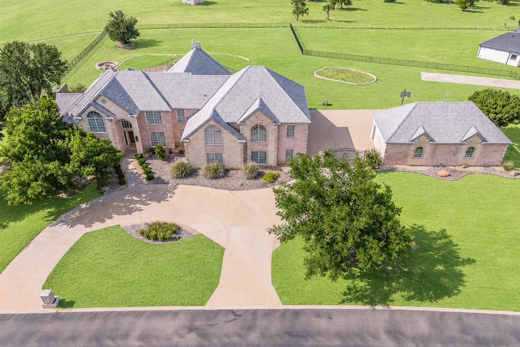 Welcome home to this magnificent estate nestled within the gated community of Canyon West Golf Club and located in the highly acclaimed Brock ISD. Situated on an elevated 1.2 acre corner lot, this exceptional property offers breathtaking views and is designed for those who love to entertain.

Ideally located with convenient access to Weatherford and Fort Worth, this custom estate seamlessly blends luxury, comfort, and functionality. The chef’s dream kitchen is equipped with premium Viking appliances and twin Sub-Zero refrigerator, creating the perfect space for hosting family and friends.

The luxurious primary suite features dual vanities, a freestanding soaking tub, an oversized dual-head shower, and a dedicated TV wall. Additional specialty spaces include an executive office, spacious game room with wet bar, upstairs and downstairs laundry rooms, a secure safe room, a private workout room complete with floor-to-ceiling mirrors and rubberized flooring, and a well-appointed mother-in-law suite.

Step outside to your own private resort-style retreat. The beautifully renovated diving pool and spa with waterfall serve as the centerpiece of the backyard, complemented by a fire pit, outdoor kitchen, pergola, and covered patio. A circular drive, gated entrance, and detached four-car garage complete this extraordinary property.

This one-of-a-kind estate offers luxury living at its finest in one of Parker County’s most desirable communities.