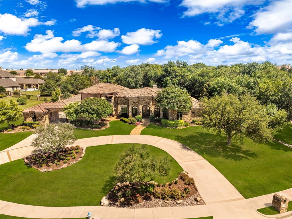 Just beyond the gates in Heath’s most established and exclusive luxury home community, just five minutes from Lake Ray Hubbard and 30 minutes from Dallas, 1739 Bison Meadow Lane offers an unparalleled Tuscan inspired lifestyle. This one of a kind 2.24-acre, heavily treed sanctuary blends timeless architecture with natural beauty to create a property that simply has no equal. Sprawling 7,231 sq. ft. of luxurious living between the main residence and Casita, the estate features 6 bedrooms, 8 full baths, 1 half bath, two exceptional outdoor living areas with full kitchen, and five garage spaces including two two-car garages and one single-car garage. Every detail from the gourmet kitchen, granite island, commercial gas cooktop, double ovens to the two-sided fireplace and groin vaulted ceilings exude refined elegance. Walls of 10-foot French doors bathe the home in natural light, highlighting stone accents, exposed wood beams, hardwood floors, and five grand stone fireplaces. Expansive outdoor living spaces feature more than 1600 ft of covered patio, a true resort-style pool, spa, a putting green and outdoor kitchen, all set amid mature trees for total peace and privacy. The primary suite is a serene retreat with panoramic views, a sitting area, stacked stone fireplace, and elegant exposed beams. The 1,161 sq. ft. luxury casita offers a spacious bedroom, office, living area, full kitchen, two full baths, and a two-car garage overlooking the pool and rolling grounds. Wake to breathtaking sunrises and unwind beneath star filled skies enveloped by the tranquility of this private one-of-a-kind paradise. Situated on a one street enclave of just 38 luxury homes, this magnificent estate offers total privacy and exclusivity with easy access to Lake Ray Hubbard, golf, dining, shopping, and entertainment. A truly remarkable offering of exceptional value. We invite you to experience firsthand why this magnificent property stands apart from all others.
