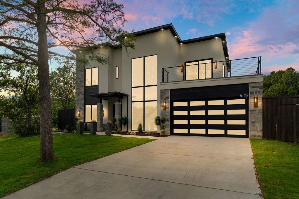 Welcome to 14015 Rawhide Parkway, a newly constructed modern masterpiece perfectly positioned in the heart of Farmers Branch. Located directly across from a beautiful park and scenic pond, this stunning residence offers the perfect blend of luxury, comfort, and convenience with nearby walking trails, the Farmers Branch Library, golf course, shopping, dining, and easy highway access all just minutes away.
This 4 bedroom, 3.1 bath home offers approximately 3,817 square feet of thoughtfully designed living space filled with natural light, soaring ceilings, and refined modern finishes throughout. The open concept layout features dramatic floor to ceiling windows, a striking floating staircase, and spacious living areas designed for both entertaining and everyday living.
The chef’s kitchen showcases custom white oak cabinetry, an oversized waterfall island, designer lighting, premium appliances, pot filler, and elegant stone finishes. The luxurious primary suite offers a spa inspired bathroom with a freestanding soaking tub, oversized walk in shower, dual vanities, and a custom walk in closet that conveniently connects directly to the laundry room.
Upstairs features additional flexible living space with a wet bar and direct access to a spacious balcony overlooking the park and pond views.
Step outside to an oversized backyard with endless possibilities, including plenty of room to build a resort style pool. The home is already equipped with gas connections for a future outdoor kitchen, creating the perfect setup for entertaining and outdoor living.
With designer finishes, incredible natural light, a massive backyard, and an unbeatable location directly across from the park, trails, library, and golf course, 14015 Rawhide Parkway offers a truly elevated lifestyle in one of Farmers Branch’s most desirable settings.