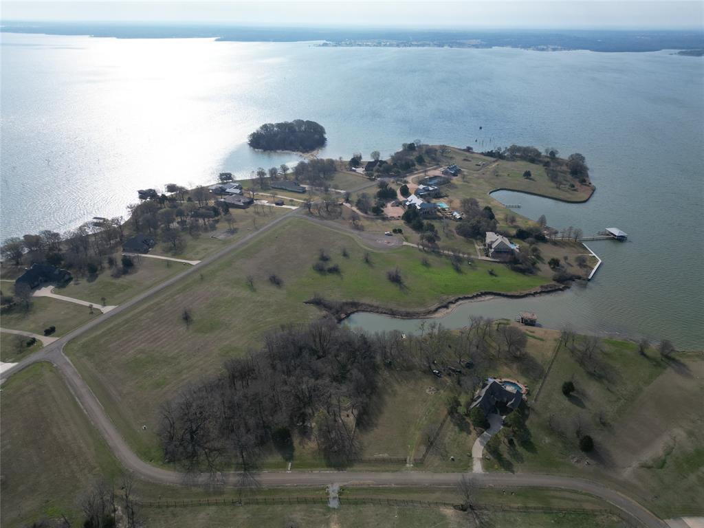 RARE WATERFRONT TRIFECTA ON RICHLAND CHAMBERS RESERVOIR! This is a once-in-a-generation opportunity to secure one of the most significant land holdings in the exclusive, gated Arrowhead subdivision.
THE LAND & WATERFRONT: This offering is comprised of three distinct parcels, each with its own unique character. Lot 38 (1.36 Acres) boasting an incredible 300 linear feet of expansive waterfront. Lot 39 (1.82 Acres) offers 65 linear feet of water access, while Lot 40 (2.2 Acres) provides an additional 100 linear feet of shoreline. Combined, you have 465 linear feet of private waterfront. Whether you choose to purchase a single lot for a secluded retreat or secure all three to create a sprawling 5.38-acre masterpiece.
THE LIFESTYLE: Life at Richland Chambers is defined by the rhythm of the water and the serenity of nature. Imagine waking to the sound of birds and the gentle lap of waves against your shore. Start your day with a peaceful sunrise paddle in your canoe or kayak, exploring the hidden coves of the reservoir. Launch your boat from the private, resident-only boat ramp to enjoy 41,000 acres of blue water. This is a world-class destination; these waters are legendary for trophy catfish, crappie, white bass, and hybrid stripers. As evening falls, the horizon transforms into a fiery canvas of Texas sunsets—the ultimate backdrop for entertaining on your future expansive deck or relaxing by a lakeside fire pit.
SUPERIOR STANDARDS: Protect your investment in a community that values quality. Arrowhead is a restricted, gated community featuring underground co-op electric and water at the road front to preserve unobstructed lake views. Homes are limited to site-built residences with a 2,500 sq. ft. minimum.
LOCATION & CONVENIENCE: Experience the best of both worlds—the profound quiet of the lake and the convenience of the city. Located just 65 miles from the heart of Downtown Dallas, this is the premier weekend escape for the DFW professional.