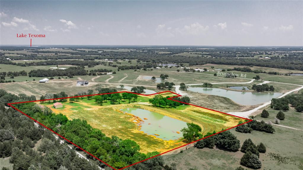 Welcome to breathtaking 1771 Brumelow Road in Whitesboro, Texas—a rare opportunity to own an exceptional 12.206 acre, AG-exempt property offering stunning panoramic views from its elevated homesite. Surrounded by the beauty of North Texas countryside, this remarkable property combines privacy, functionality, and endless potential.

The land is highlighted by a large scenic pond, a productive 200-foot-deep water well delivering approximately 17 gallons per minute, and an impressive 30' x 40' spray foam insulated shop with electricity already in place. The shop has been thoughtfully designed with rough-in plumbing for a future kitchen, bathroom, and loft, making it ideal for a guest quarters, barndominium conversion, workshop, or recreational retreat.

Conveniently located just minutes from Lake Texoma and the charming town of Whitesboro, this property offers the perfect balance of peaceful country living and easy access to dining, shopping, recreation, and major amenities.

Properties of this caliber are seldom available. Whether you're seeking a private estate, weekend getaway, recreational property, or future homesite, this is truly one of the most beautiful tracts you'll find. Recent survey available. Don't miss your chance to own this extraordinary piece of Texas countryside.