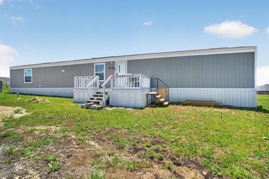 Charming 3-bedroom, 2 bath single wide mobile home situated on a spacious 1 acre lot in sought after Godley ISD! Enjoy peaceful country living with no city taxes and plenty of room to spread out. The open concept kitchen, living, and dining area creates a functional layout perfect for everyday living and entertaining. Wood laminate flooring flows throughout the main living spaces, and the separate utility room just off the kitchen adds convenience. Relax on the front deck and take in the quiet surroundings while enjoying all the perks of country life!