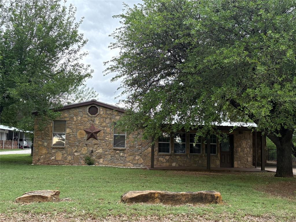Welcome to 210 Jones Rd at Possum Kingdom Lake. This 3 bed 2 bath property has it all as it is a well established family home. Inside the home you will open up to a nice, large living room, then stepping up to a beautiful kitchen and dining area. It has a designated laundry room, walk in pantry, large master bedroom with an ensuite including a big bathtub and walk in closet. What you will find outside just completes this property- 2 car attached carport, fenced in back yard, beautiful shade trees, detached 4 car carport and last but certainly not least, a 25x30 metal building shop with 2 roll up doors and a loft area for extra storage space. New indoor and outdoor AC units were installed in 2024. Located in a quiet neighborhood- still in the amazing Graford school district but only a few minutes drive to the lake for a beach day, you get the best of both worlds here!