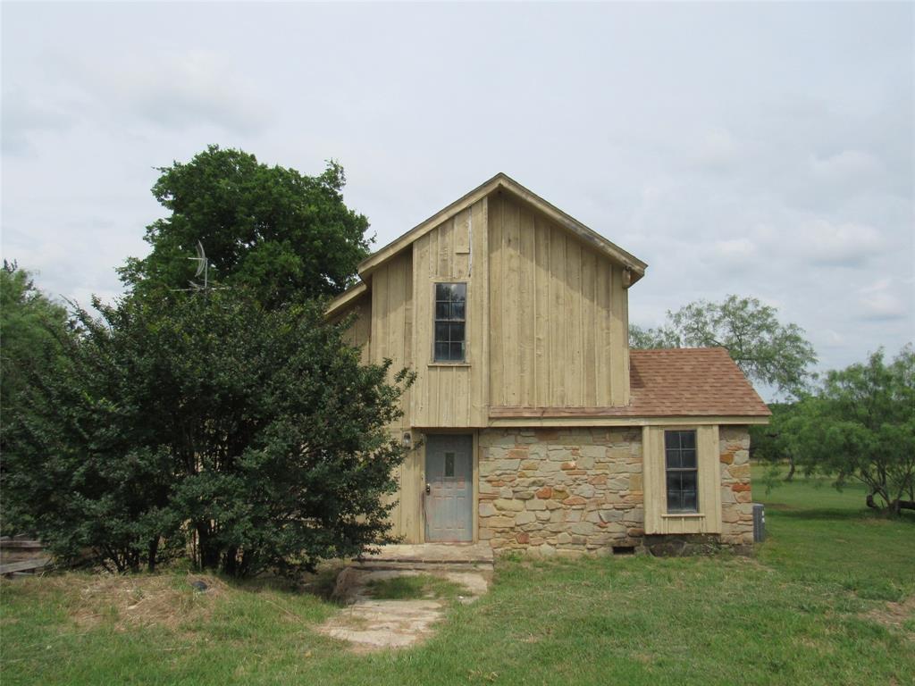 Great lake view home in rural community and boat ramp access just down the street on Lake Aquilla! This charming 3 bedroom, 2 bath Cedar house has beautiful view of Lake Aquilla from first floor deck 30x 16 and 2nd floor balcony 16x 10. Large living room with high ceiling, lots of windows for light and view, large rock fireplace. All this in a country setting. With one bedroom down, and another on the second story with a sliding glass door and walkout deck, you'll have plenty of space and convenience on this quiet street. Come take a look today!