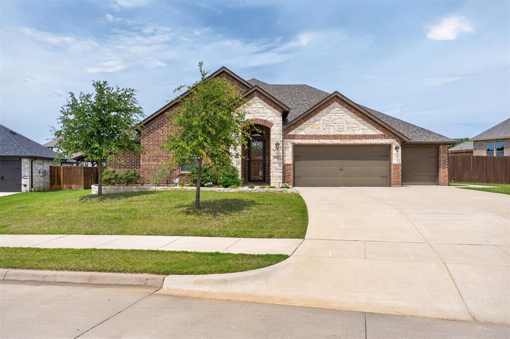 Beautifully appointed home in the desirable Oak Hills Addition, offering exceptional space, thoughtful design, and upscale finishes throughout. This versatile floor plan was originally designed as a 4 bedroom home, with bedrooms two and three currently combined to create an oversized secondary bedroom that could easily be converted back to a fourth bedroom if desired. The gourmet kitchen features granite countertops, stainless steel appliances, double ovens, a butler’s pantry, and an oversized walk-in pantry perfect for entertaining and everyday living. The luxurious primary suite offers separate vanities, a freestanding soaking tub, an impressive walk-through shower with dual spray heads and controls, plus a large secondary closet with direct access to the utility room for added convenience. Additional highlights include two full baths, a convenient half bath, a spacious utility room with room for an extra refrigerator or freezer, and a 4 car garage with a drive-through tandem bay. Situated on an oversized lot of more than one-third acre with a full sprinkler system and a large covered patio, this home combines comfort, function, and style in one exceptional package.