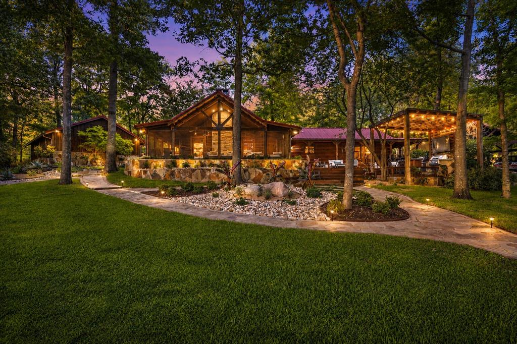Set along the coveted shoreline of Lake Bob Sandlin, this exceptional waterfront retreat offers a rare blend of refined luxury and timeless East Texas charm. Nestled on approximately 0.87 acres beneath a canopy of mature trees, this custom log-style residence is designed for both elevated living and effortless escape. Inside, rich wood interiors, vaulted ceilings, and expansive living spaces create a warm yet sophisticated atmosphere. The open-concept design is anchored by a striking wood-burning fireplace, while the chef’s kitchen features an island, abundant cabinetry, and seamless flow for entertaining. Thoughtfully designed with all bedrooms on the main level, the home balances comfort with intentional functionality. Outdoors, the experience continues with multiple curated living spaces including a screened porch, covered patio, outdoor entertaining area, and a private boathouse—perfect for enjoying tranquil lake views and year-round gatherings. The guesthouse, thoughtfully situated to provide privacy while remaining easily accessible to the main residence, features a spacious living area and full bathroom. This versatile space is ideal for accommodating friends and family, or could serve as a comfortable home office or studio. With its own dedicated entrance and picturesque lake views, the guesthouse offers guests a peaceful retreat that complements the property's overall sense of hospitality and relaxation. Whether envisioned as a private waterfront estate, luxury weekend retreat, or legacy property to be enjoyed for generations, this Lake Bob Sandlin offering delivers an unmatched lifestyle defined by serenity, space, and sophistication.