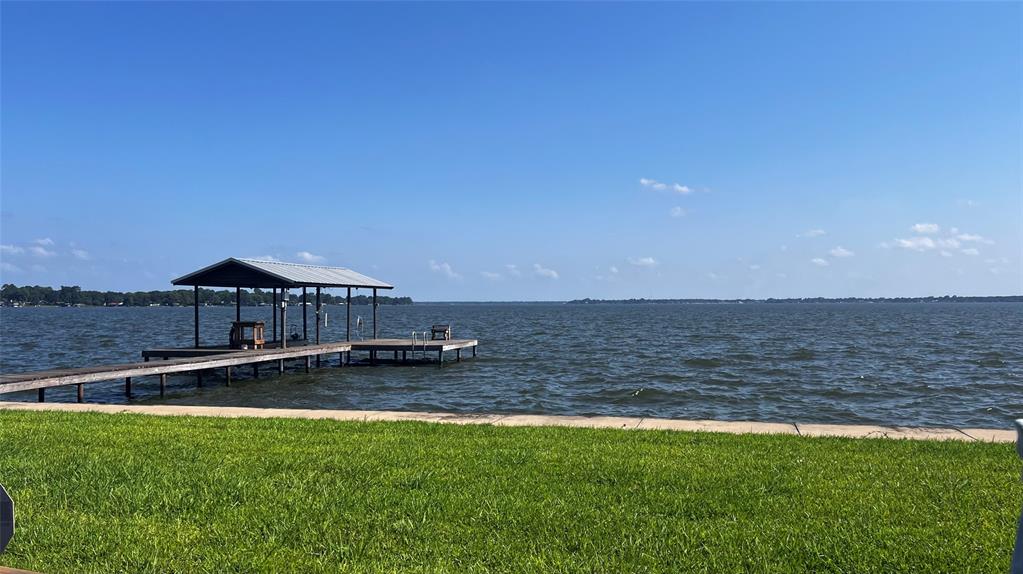 Incredible opportunity to own 3 contiguous improved Waterfront lots on the main body of Cedar Creek Lake! With approximately 200 feet of open water frontage, this rare offering provides the perfect canvas to build your custom lakefront retreat. Enjoy breathtaking, panoramic views that stretch down the length of the lake—ideal for sunrises, sunsets, and everything in between. A steel retaining wall with concrete topper is already in place, along with a covered single-slip boathouse and sun deck for lounging, fishing, or entertaining by the water. Whether you're dreaming of a luxury lake home, a family compound, or simply investing in premium waterfront land, this property offers the space, setting, and versatility to bring your vision to life. Located only an hour from the Dallas metro area and is just minutes from local shopping, dining, and boat-up restaurants, this location combines lakeside tranquility with everyday convenience. Don’t miss this one-of-a-kind lakefront gem on Cedar Creek Lake!