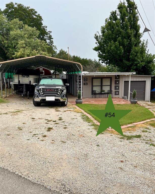 MOTIVATED SELLERS ~ READY FOR OFFERS! Looking for a lake place that provides serene surroundings, a friendly community, and low maintenance?  Here it is, just waiting for you in Golden Cove on Possum Kingdom Lake! Several years of continuous upgrades and improvements make this awesome lake place a hidden jewel! This stucco finished home has been fully redone from the floors up. Features include a metal roof, covered patio, detached carport with enough room for watercraft or RV, attached garage with roll up door with room for atv or golf cart, separate storage shed, and a spacious covered deck with a bar, outdoor cooking area, and LAKE VIEW overlooking the swim cove. Inside you'll enjoy an open living-dining concept, new sub-floors and vinyl plank flooring throughout, a new stainless steel appliance package, living room fireplace, stacked washer & dryer, two bedrooms - one with en-suite bath, plus a  bonus room with a wood-burning stove that opens to the back deck. Nicely furnished and ready for new owners!  Must see to appreciate! Monthly lot lease $865