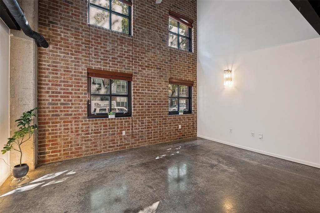 Freshly painted with newly installed carpet, this State Thomas condo is ready for immediate move-in.  A dog lover's paradise, the building back gate opens directly to Griggs Park.  This charming loft features exposed brick walls, stained and newly polished concrete floors on the first floor and a loft primary suite on the second floor.  The open floor plan includes a kitchen is complete with stainless appliances, granite counters, and an island.  Full sized washer and dryer combined with a powder bath complete the first floor.  The spacious primary loft includes a custom designed master closet and spacious master bath with glass block wall. Easy access to Uptown restaurants, shopping, Downtown and The Arts District.  Resident amenities include a patio area with grill, fitness room, pool, and a rooftop patio to enjoy the beautiful Dallas skyline.  Assigned parking space #90 on level P2.
