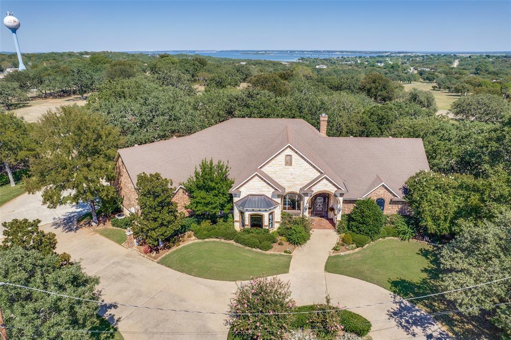 Welcome to this stunning custom home nestled at the end of a quiet cul-de-sac, perfectly positioned to offer breathtaking views of the golf course just beyond your backyard. This meticulously maintained residence combines timeless elegance with modern comfort, featuring 3 spacious bedrooms, 3 full bathrooms, and 3 convenient half baths.

From the moment you arrive, you'll be captivated by the oversized iron front door—an impressive statement that sets the tone for what’s inside. Step into the warm and inviting family room where a classic wood-burning fireplace becomes the heart of the home, ideal for cozy evenings or entertaining guests.

The thoughtfully designed kitchen is a chef’s dream, featuring a large center island with an electric range, a decorative vent hood, and a picturesque window above the sink that frames serene backyard views. Whether you're preparing meals or gathering with friends and family, this space blends function with charm.

The dedicated office offers both productivity and privacy, complete with elegant wood ceiling detail, custom built-ins, and double doors to keep your workday undisturbed.

Upstairs, the secondary bedrooms offer comfort and style, and one features access to a private balcony—perfect for morning coffee or enjoying the peaceful golf course setting at sunset.

The outdoor living spaces are equally impressive. The oversized covered patio is ideal for al fresco dining, relaxing, or simply soaking in the expansive views of the manicured fairways just beyond the fence line. It's a true extension of the home and a rare find in a setting like this.

This home offers the ultimate in privacy, luxury, and scenic living. With its premium cul-de-sac location, refined interior features, and direct golf course views, this property is a must-see for those seeking the perfect blend of comfort and sophistication.