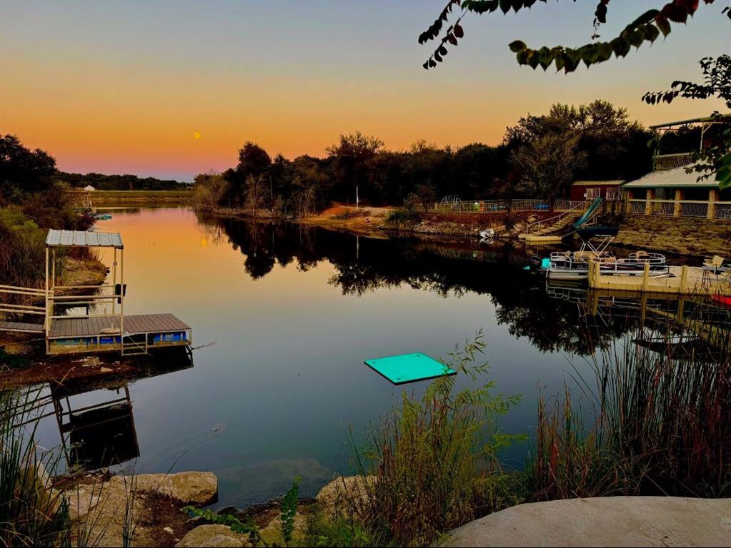VIP Open Ranch Event – Nov 18th, RSVP Required. Lake Godstone is a 188-acre premier recreational ranch and campground in Jack County, Texas. This beautifully unique property features a 4-acre, 40-foot-deep spring-fed lake stocked with trophy largemouth bass, surrounded by scenic trails, diverse habitat, and thriving wildlife—including trophy whitetail deer managed under a wildlife management tax exemption.

Purpose-built for retreats, outdoor recreation, and hospitality, Lake Godstone hosts up to 60+ guests across a variety of well-appointed accommodations. The 6-bedroom, 3-bath lodge offers 35 beds and panoramic lake views. Additional improvements include six cabins, two RV sites, multiple primitive campsites, and a modern bathhouse. Supplemental power by a 40 KW solar-integrated power plant and private water wells. 

With a proven annual income and consistent five-star reviews, this property blends recreation, revenue, and conservation in a way rarely found in North Texas. Lake Godstone represents an exclusive opportunity for investors, families, or organizations seeking a turn-key legacy ranch within 90 minutes of the DFW Metroplex.

Highlights
-188± acres with 4-acre, 40’-deep spring-fed Lake Godstone
-Trophy largemouth bass and whitetail deer
-Wildlife management tax exemption
-$240,000 annual income from lodging and recreation
-6-bed, 3-bath lodge (35 beds total)
-6 cabins, 2 RV sites, multiple campsites, and modern bathhouse
-40 KW solar power plant with backup generator
-Sleeps 60+ guests comfortably
-Proven event and lodging infrastructure
-90 minutes from DFW
-VIP Open Ranch Event – Nov 18th, RSVP Required