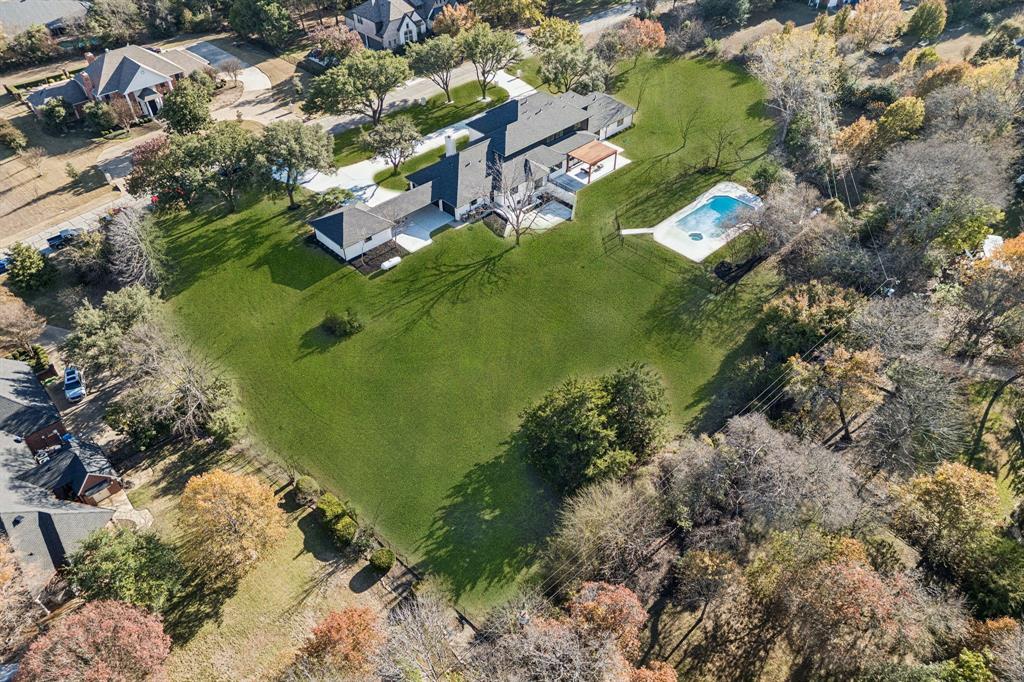 Situated on nearly 2.5 acres in prestigious Lovejoy ISD, this extraordinary 8,097 sq ft estate has been completely reimagined through a full-scale luxury renovation featuring entirely new interior construction and designer finishes throughout. Showcasing soaring ceilings, sophisticated architecture, and exceptional craftsmanship, the home offers a seamless blend of modern elegance and refined comfort. This expansive 5-bedroom residence includes 6 full bathrooms and 2 half bathrooms, thoughtfully designed for both grand entertaining and everyday living. A striking iron front entry opens to dramatic high ceilings and two stunning living areas, each centered around its own fireplace. The main level also features a private office, formal dining room, and an exceptional primary suite designed as a true retreat. Highlights include a fireplace, infrared sauna, standalone soaking tub, towel warmers, dual vanities, and an oversized custom closet complete with an island and its own dedicated laundry room. The chef’s kitchen is beautifully appointed with white oak cabinetry, quartz countertops, under-cabinet lighting, and an expansive butler’s pantry with abundant prep space, ideal for hosting and daily functionality alike. A fully finished basement adds even more versatility with a bar area and full bathroom. Upstairs, a spacious open-concept family room creates an ideal gathering space alongside three ensuite bedrooms featuring walk-in closets, an additional half bath, and a dedicated media room. Designed for elevated outdoor living, the property features a gated pool, cedar pergola, and beautifully landscaped grounds that provide both privacy and serenity. A spacious 4-car garage with epoxy flooring completes the estate. Ideally positioned off Stacy Road near Highway 75, and just minutes from The Villages of Allen, this remarkable property offers convenient access to premier shopping, dining, and entertainment while maintaining the privacy and exclusivity of estate living.