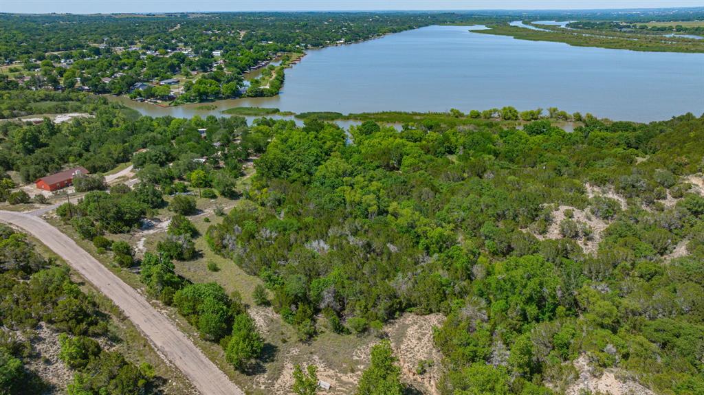 Rare opportunities like this don’t come around often on Lake Granbury. Spanning approximately 5 waterfront acres with an incredible 1,800 feet of shoreline, this property offers the kind of flexibility, privacy, and investment potential that buyers dream about. Whether you envision developing multiple luxury lakefront homes, creating an income-producing getaway, or building a private estate for your family, this property is ready to deliver.
Approximately 800 feet of reinforced seawall adds both functionality and peace of mind, while the expansive waterfront views create a stunning backdrop in every direction. The land offers multiple prime build sites with room to design something truly special — from modern lake homes to a legacy property meant to stay in the family for generations.
Already equipped with 3 RV hookups, the property is perfectly set up for weekend escapes, hosting friends and family, or living comfortably on-site while constructing your dream home. Imagine mornings with coffee overlooking the water, evenings around a fire pit, and direct lake access right outside your door.
Properties with this much shoreline, usable acreage, and development potential on Lake Granbury are exceptionally hard to find. Whether you're an investor, developer, or someone searching for an unmatched waterfront lifestyle, this property is a chance to create something extraordinary.