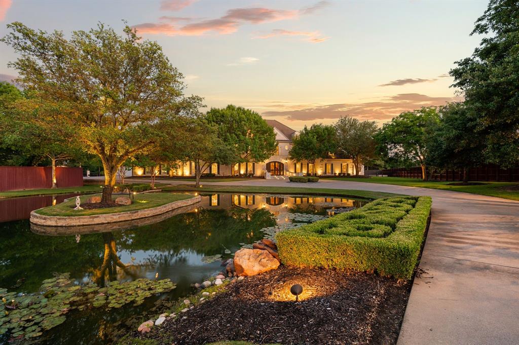A RARE opportunity to own one of Southlake’s most prestigious properties, where Resort Living meets Texas Grandeur. This extraordinary resort-style estate spans approximately 3 private acres and exudes excellence from the moment you pass through the private gated entrance. A breathtaking drive up experience welcomes you home as you pass three stunning stocked ponds with waterfall oasis features, creating a setting that few homes in this region can rival. The main residence offers 9,604 square feet of luxurious living space, while the total 10,496 square feet includes the beautifully appointed pool house. The main house Features 5 expansive bedrooms all with private en-suite baths and 3 half bathrooms, and 2 laundry rooms, every space in the home was thoughtfully designed to deliver both grandeur and comfort. A private well services the property, further enhancing the estate’s functionality and exclusivity.The home features a chefs kitchen equipped with stainless steel Viking appliances, a built-in Sub-Zero refrigerator, and wine cooler, perfectly designed for both entertaining and everyday living. The luxurious grand primary suite is highlighted by custom-built glass cabinetry in the master closets, creating a sophisticated, hotel-inspired design aesthetic. Step outside to a stunning backyard retreat featuring a resort-style pool, fire pit, and beautifully designed outdoor living spaces that create the ultimate private oasis. Designed for elegant entertaining and elevated everyday living, this remarkable PREMIERE estate offers exceptional privacy in one of Southlake’s most coveted locations, just minutes from Southlake Town Square and DFW International Airport.
