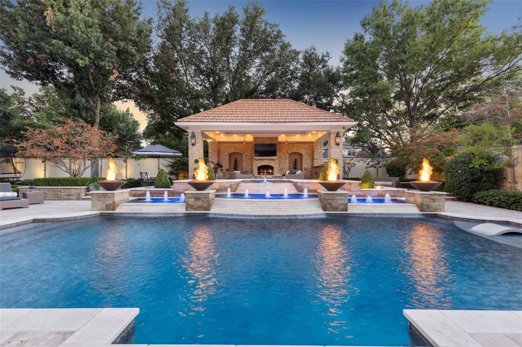 This newly renovated Willow Bend Country residence is situated on a quiet cul-de-sac and offers high-end features throughout. The heart of the home is the opulent kitchen, which boasts custom cabinets, a 14-foot island, a built-in wine fridge, an ice machine, two dishwashers, a La Cornue range, Waterstone fixtures, custom lucite hardware, a walk-in pantry, and a dedicated coffee bar. The primary suite is a true retreat, featuring a spa-inspired bathroom with two spacious closets, a rainfall shower, and marble floors. Additional features of the home include custom window treatments, Schumacher wallpaper, white oak floors, designer carpet, whole-house water and air filtration, a tankless water heater, sparkling chandeliers, a downstairs media room, and new iron and glass doors. Outside, a private oasis awaits with a sparkling pool, a hydrotherapy spa, and an expansive stone and turf outdoor area designed for year-round enjoyment. Don't miss your chance to own this gorgeous property!
