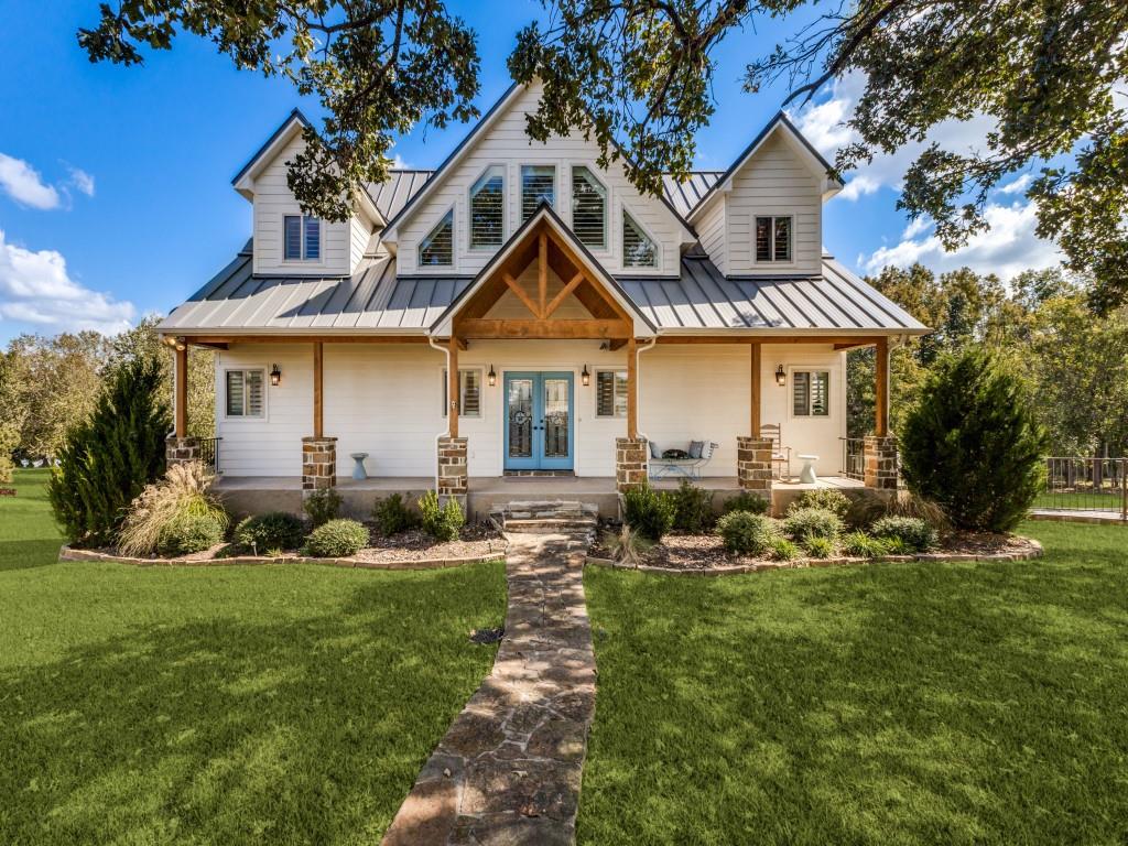 Nestled in the highly sought-after Waters Edge community bordering a 328 acre private lake, this charming four bed, four and a half bath lakefront retreat perfectly combines modern comfort with timeless lakeside charm on a beautiful acre. On arrival the home's towering oak tree and tranquil setting create an immediate sense of peace and connection to nature. Expansive windows throughout the home frame breathtaking lake views from nearly every room.  Designed for both relaxation and entertaining, 5848 Lago Vista boasts three generous living areas and a sauna!  Heart of the home are the light filled kitchen, adjacent breakfast nook and great room. Each bedroom has an ensuite bath and ample closet space.  Primary suite is on the main floor. The attached garage and plentiful storage ensure every lake toy and belonging has a place.  Outside is your own waterfront paradise.  Enjoy s'mores over the fire pit or endless days on the two story dock.  Whether it's the quiet morning coffee overlooking the water or a lively gathering under the stars, this home was made for making memories.  Residents of Waters Edge have access to a resort-style pool, pickleball court, wildlife preserve and marina, all within a secure and beautifully maintained community.  With its prime lakefront location and luxury amenities this Waters Edge, Athens property represents lakefront living at its finest -- a rare combination of space, style and serenity.
