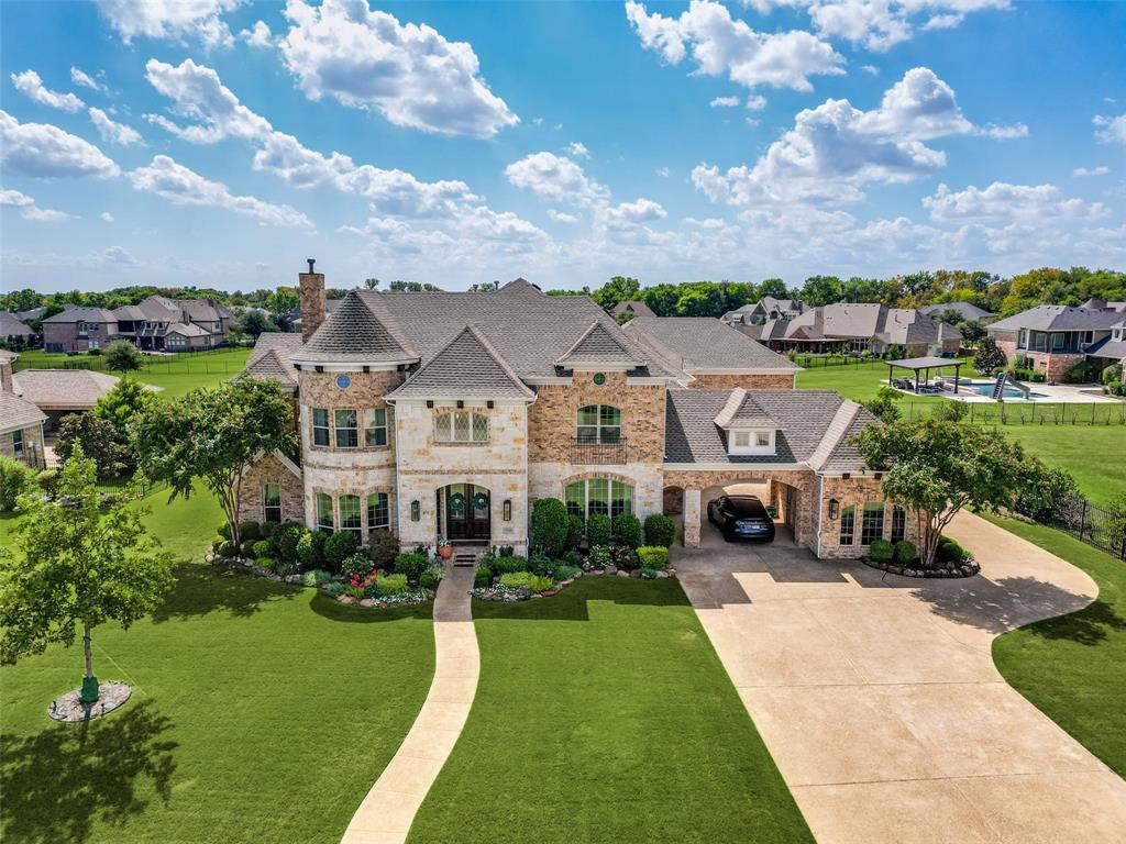 Super luxurious home recently updated with premium materials and workmanship throughout, plus a fabulous pool & spa like no other!  This home offers a great architectural drive up appeal with a private circle around garage porte-cochere that creates a private motor court and sheltered entrance and discreetly hides the garage from the front of the home.As you walk to the beautiful double door front entry with covered porch, you will  notice gorgeous landscaping and landscape lighting.  Enter to recent new herringbone wood floor entry with round rotunda area with dramatic double stair cases and formal dining and living areas to each side. A secondary bedroom is off of the living area with closet but is currently being used as a second study. Proceeding to the back of the  home you will find another generous living area open to the kitchen with hardwoods, fireplace and a wall of windows showcasing the beautiful pool and multiple outdoor living areas. Gourmet kitchen offers recently installed Sub Zero refrigerator, beautiful cabinetry,large island, lots of storage, updated lighting and walk in pantry.The chef has her own study off the kitchen which can also be used as an additional serving area, butler's pantry or wine grotto, depending on your lifestyle.  To the back of the home is a third private bedroom, bath, mudroom, second staircase and utility room. The the rear on opposite side is primary suite with see-thru fireplace, spa like bath and view of the lovely pool area. Upstairs you will find 3 bedrooms, children's study & private play area.This area was recently added and is not reflected on the tax records square footage or the square footage in the MLS, but is roughly 300 square feet. Outdoor covered balcony over looks the beautifully landscaped pool and yard.  Don't forget the awesome game room and media room! The owner has updated this home to showcase superior finishes, added many new built-in cabinetry, the pool & spa ,fence and outdoor living area