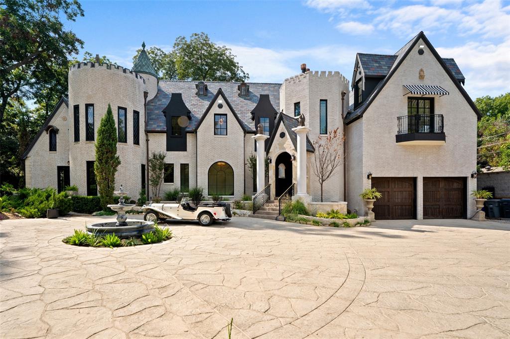 ONE OF THE GREATEST LANDMARKS IN DALLAS, TX IS ON THE MARKET. This estate takes your breath away just watching the original custom iron gates open. Yes, this is the original home of R.L. Thornton. Built in 1927, the Chateau was built in its day for those who lived like the Rich and Famous. Needing an abundance of privacy? Another set of original iron private gates to service owners and guest through the alley are still in place.  Sitting on approximately an acre, the entire grounds are full of stone walkways, moat, sculptures, multiple water features, archways, and private sitting areas both above ground as well as underground, much of which is original. The home which was once was 3,200 sf and is now 7,577 sf. The current owner, along with his builder did a phenomenal job at bringing the old to the new giving the home a place to live in the way we prefer in 2025. This house misses nothing. You have 4 floors total. The fourth floor is a castle Tourette large enough for a small party to enjoy your view of the grounds from above and enjoy a cocktail while watching the sunset. You have 6 bedrooms, 4 full baths, 2 half baths, 2 offices, 2 family rooms, 2 dining areas, a basement with a wine room, and open bar area. All said this is not even half of the things to mention. It's a come and see with your own eyes. Look forward to seeing all of you.