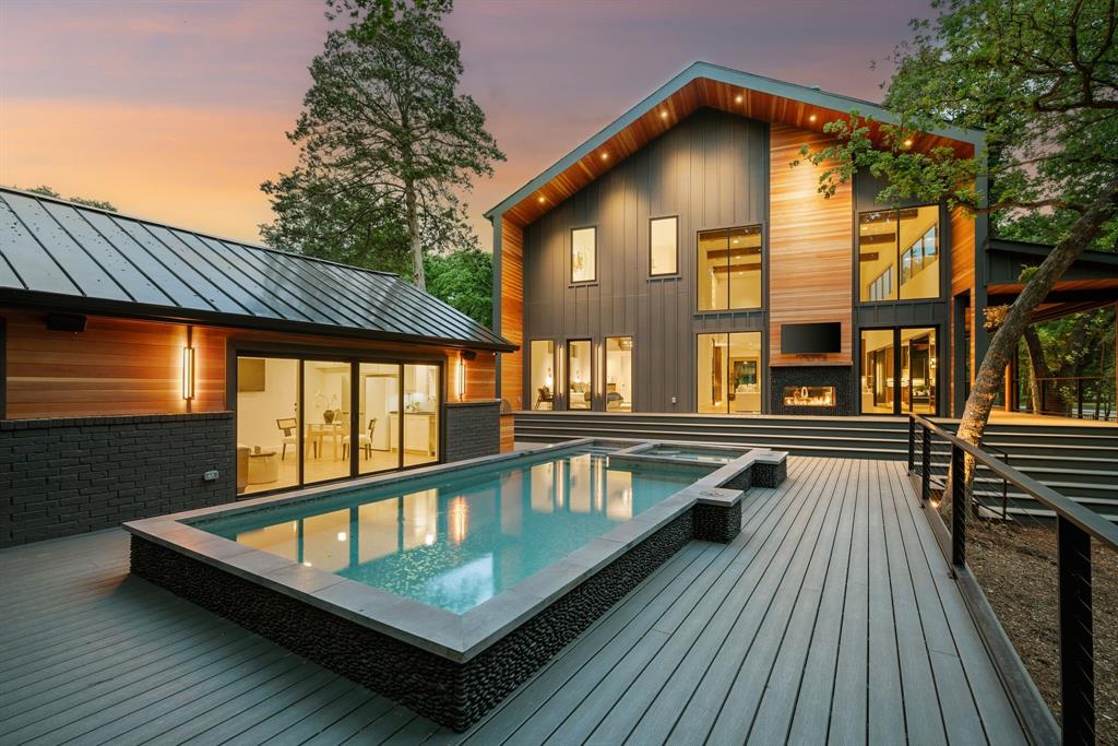 There’s a moment when you arrive—when the trees part just enough to reveal a home that feels as if it was always meant to be here. Set on a full acre draped in greenery and bordered by a quiet creek, this newly completed 5,160 sf Southlake estate invites you to experience luxury in its most natural form. Step inside, and the scale immediately takes your breath. Ceilings rise to 21 feet, and entire walls of glass bring the outdoors in—sunlight filtering through the trees, reflections shifting with the day.
At the heart of the home, the kitchen tells its own story. Designed for those who love to cook and gather, it flows effortlessly into a hidden butler’s pantry, fully equipped with a second kitchen. Just beyond, doors lead to an 1,800-square-foot outdoor living area, where retractable screens frame a seamless indoor-outdoor lifestyle.
The master suite is a retreat of its own—with a spa-inspired bath wrapped in glass. A wet room with a steam shower and soaking tub creates relaxation, 
There’s room here for everyone—five en-suite bedrooms, an upstairs game room with a built-in bunk area, and a private 480-square-foot guest home with its own entrance, perfect for extended stays or quiet independence. Even daily routines are elevated with three laundry rooms, a climate-controlled wine room, and a beautifully appointed office with peaceful views.
Every detail has been considered. Every finish, intentionally chosen. Built by the visionary team at Highpoint Homes, this estate is more than a residence—it’s a place that feels like home from the very first day.