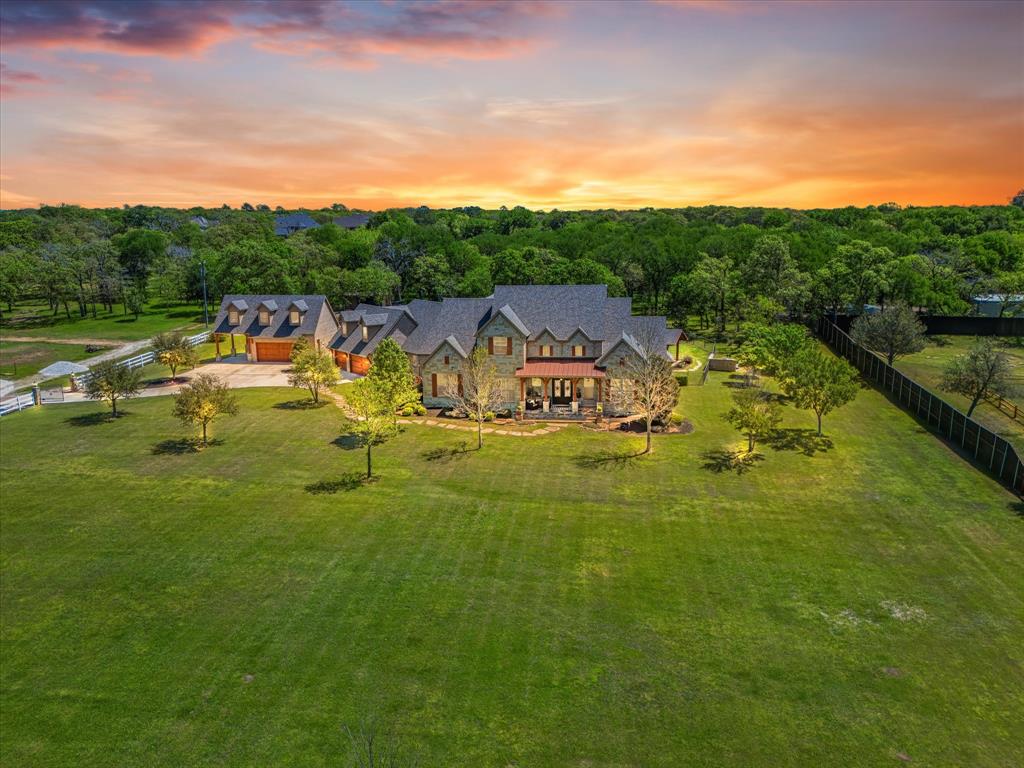 LIVE YOUR DREAM. LUXURIOUS, PRIVATE, IMPECCABLE 4 BED 5 BATH HOME NESTLED ON 3.67 BREATHTAKING BEAUTIFULLY LANSCAPED TREED ACRES OVERLOOKING NATURAL POND. Exquisite custom design & finish elements in & out w architectural detail in millwork, elegant arches, stonework, extensive crown molding, & ceiling woodwork. Outdoor living at its finest w approx. 1200 sq ft of covered patio w fireplace overlooking sparkling pool, spa, & manicured grounds. 1st floor living includes ensuite Primary & Guest bdrms, Living room, Formal Dining, Game room, Media room, Office, Custom chef's kitchen w Dinette, Mud room, Laundry room butler pantry combo, & half bath.
2nd floor living includes 2 ensuite bdrms plus 421 sq ft of unfinished flex space. Tastefully decorated, freshly painted, this pristine estate's been recently inspected, appraised, & is in excellent move in condition. Bring your horses or just enjoy a tranquil serene setting minutes from Southlake Town Center, DFW Airport, & Alliance.