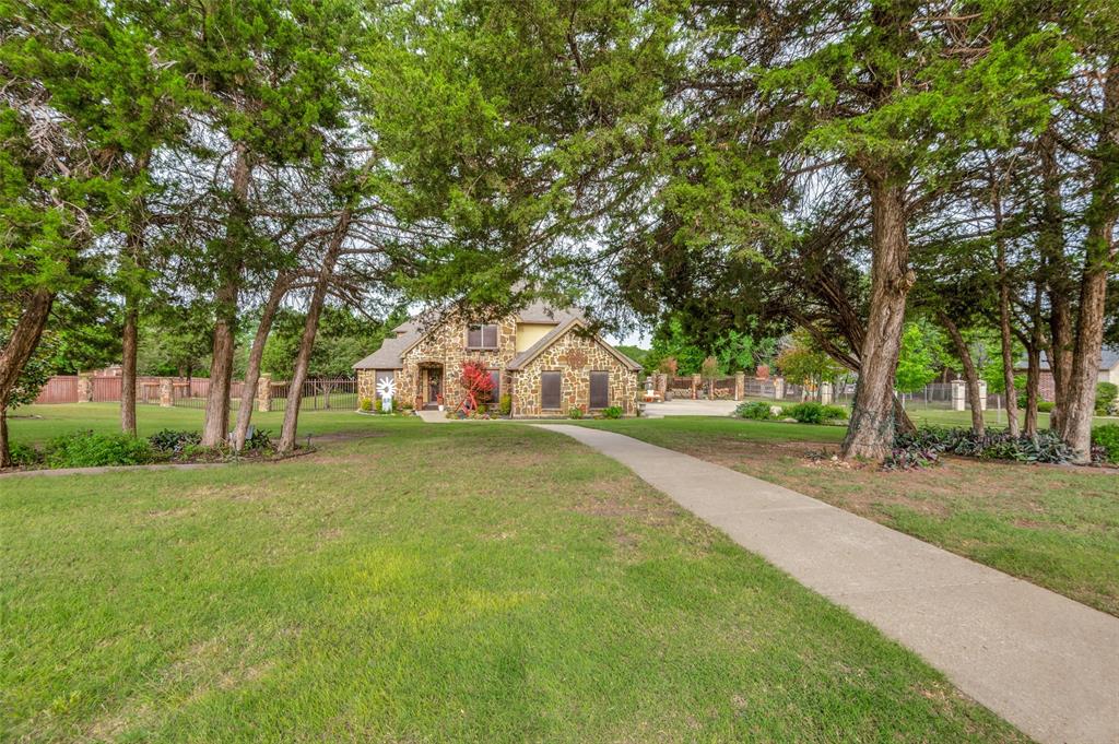 REDUCED: Elegant Estate on 2.4 Acres – Prime Dallas Location:
This stunning 4-bedroom, 4 full bath, 2 half bath estate sits on 2.4 acres and offers the perfect blend of privacy, elegance, and convenience. Ideally located just 25 minutes from DFW International Airport and 20 minutes from downtown Dallas, you’ll enjoy the serenity of country-style living with city amenities at your doorstep—shopping and dining are right across the street. Walk across the street to Target, Panera Bread, Jason Deli, Salt Grass, Best Buy, the mall (H&M, Barnes and Noble + much more).

Built with a timeless combination of rock, stucco, and brick, this home is as durable as it is beautiful. Inside, the thoughtful design features hand-scraped hardwood floors, 3 fireplaces, and a double stairway leading to expansive living spaces. With 5 separate living areas, there’s room for every occasion—from intimate gatherings to large celebrations.

The updated chef’s kitchen is a showstopper with a built-in ice maker, beverage fridge, and 44-bottle wine refrigerator. Retreat to the oversized bedrooms, each designed with comfort in mind. Entertainment lovers will appreciate the private theatre room with a wet bar, full bathroom, microwave, under-counter refrigerator, and its own walk-out balcony.

Step outside to your personal resort: a covered outdoor living area with full kitchen, perfect for year-round entertaining, and an 8-foot diving pool for summer fun. Second outdoor patio added overlooking the pool.  A 3-car garage with additional parking ensures plenty of space for vehicles and guests.  Buyer, please verify schools and bedroom sizes.

This home truly has it all—luxury finishes, modern updates, generous space, and unbeatable location.  Green house plus 3 storages on the property.  3 fruit trees (pomegranate, peach and pear tree).