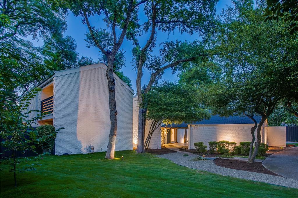 Set on over half an acre of towering, mature oaks, 6815 Woodmark Court is a striking study in contemporary design meeting the natural world. The home seems to rise directly out of its wooded lot — a rare pairing of architectural boldness and true seclusion, just minutes from the heart of Dallas.
The interior has been thoughtfully curated to match the home's striking exterior. Rich oak hardwood floors flow seamlessly throughout the entire residence, leading you into a fully reimagined kitchen. This culinary heart of the home features crisp white cabinetry and sleek quartz countertops, providing a bright, modern contrast to the verdant views outside. With five spacious bedrooms and 3.5 updated baths, the layout offers plenty of room to breathe while maintaining an intimate connection to nature.
Multiple private balconies extend the living space outward, each framing sweeping canopy views over the wooded lot below. It's the kind of elevated perspective rarely found this close to the city — mornings framed by dappled light through the oaks, evenings spent overlooking a completely private, tree-lined retreat.
Situated in one of the most sought-after sections of Dallas, this property places you in an enviable location. You are just moments away from the city's premier private schools and a variety of places of worship, blending true privacy with the convenience of a prime urban address. This is a home for those who want architectural distinction without sacrificing seclusion or connection to nature — a rare combination in one of Dallas's most established neighborhoods.