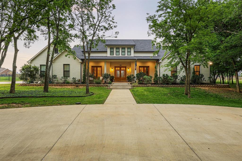 Stunning custom-built home situated on a beautifully treed one-acre lot in The Woods of Gunter ISD, tucked away on a quiet street with peaceful pond views from the inviting front porch. Designed with both comfort and entertaining in mind, this 4-bedroom, 4.5-bath home features an open-concept floor plan with a gourmet kitchen complete with built-in appliances, oversized refrigerator, abundant cabinetry, and expansive prep and gathering space. Every bedroom includes its own private ensuite bathroom, offering comfort and privacy for family and guests alike. The spacious living and dining areas flow seamlessly to the incredible oversized back patio and the 40 gallon - 10 foot deep pool, creating the perfect setup for hosting family and friends year-round. Upstairs, a large bonus room above the garage offers the ideal extra hangout space, game room, or media area, along with convenient walk-in attic access for additional storage. Surrounded by mature trees and offering a private, serene setting, this property combines luxury, functionality, and the charm of country-style living while still being conveniently located near the heart of growing Gunter.