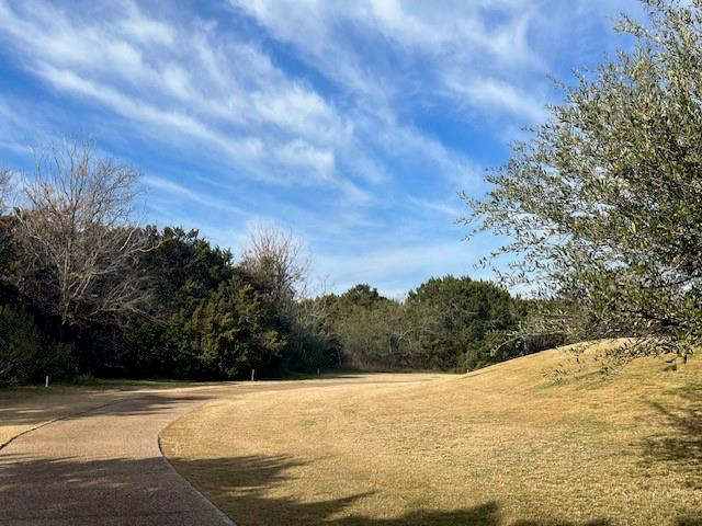 Golf course lot available on the 14th hole of White Bluff Resort's new course at Lake Whitney, TX. This community offers lake access, fishing, golf, hiking, pools, and a pub with sunset views. Build or hold the lot and enjoy amenities including marina, Cascade pool, Lighthouse Pub, parks, catch-and-release ponds, plus thousands of acres for exploring and wildlife watching. Membership includes 36 rounds of golf, access to four pools, two golf courses, restaurant, tennis courts, pickleball courts, marina, boat ramps, cabins, condos, and hotel.