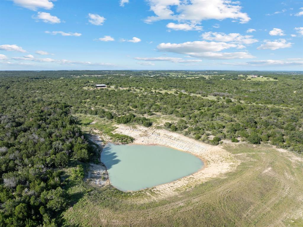 Extraordinary Estate on 385+ Acres – The Crown Jewel of the Region! 

Welcome to the largest and most exclusive ranch in the private, gated community of Legends of Buffalo Ridge. Experience a rare and remarkable opportunity to own over 385 acres of unspoiled, panoramic beauty. This versatile property is ideal as a luxurious primary residence, multigenerational family compound, weekend retreat, or even an extravagant hunting lodge. 

From the moment you arrive, you’re greeted by modern glass entry doors that offer a stunning preview of the exceptional design within. The interior showcases a dramatic grand center staircase, setting the tone for the thoughtfully curated finishes throughout. 

Inside, the home features three generously sized bedrooms, including two primary suites. Two spacious living areas are designed for comfort and flexibility. The heart of the home boasts a custom built-in dining island for large family gatherings, perfectly suited for entertaining on a grand scale. 

Those seeking self-sufficiency will appreciate the whole house generator, two wells, two 50-amp RV hookups, plus an above ground gas tank and diesel tank. Your hunter's paradise is complete with three deer stands, feeders, and multiple sources of water. Your livestock will thrive in a turnkey experience being fully fenced and cross fenced with secure gated access. The ocean-like stock tank is ideal for fishermen and provides the ultimate waterfront experience. 

This estate offers rolling terrain, breathtaking views, and absolute seclusion. Properties of this magnitude, privacy, and craftsmanship are exceedingly rare.  Don't miss this once-in-a-lifetime chance to own signature acreage in this unmatched prestigious ranch community.