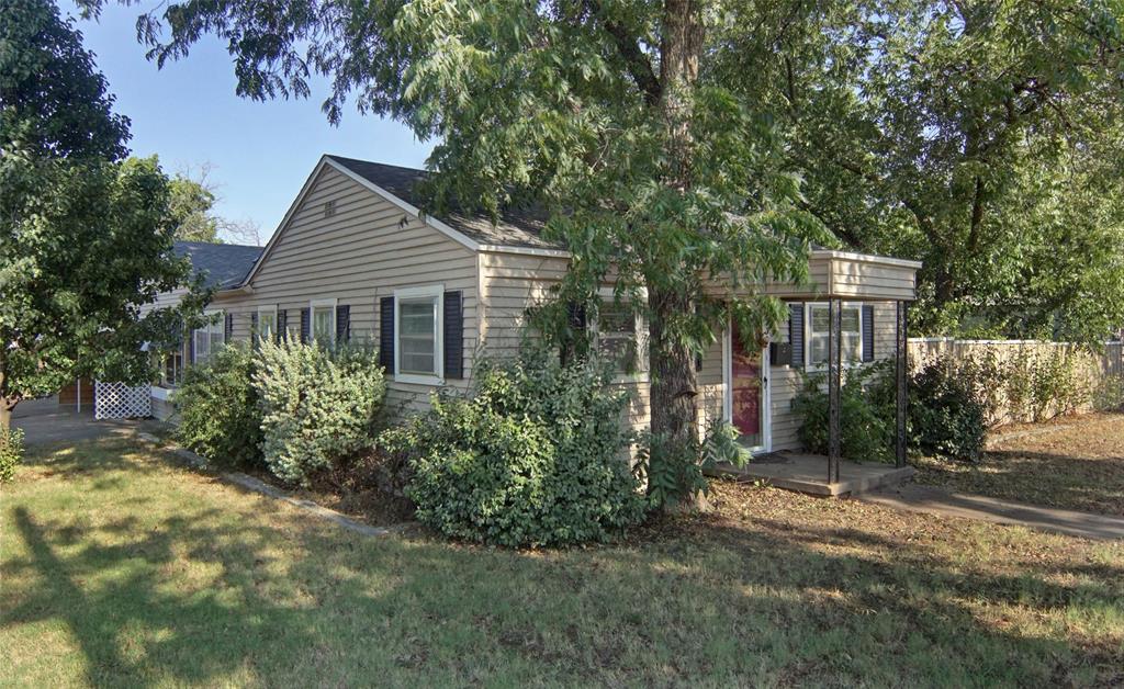 Welcome to this one-of-a-kind property filled with charm and opportunity, located in the desirable College Heights neighborhood on two lots with five mature pecan trees. This home offers 2 bedrooms, 2 bathrooms, and a versatile flex room that can serve as a second living space or third bedroom, plus an additional bonus room off the main hallway—perfect for a home office, hobby space, or cozy reading nook. The wood-burning fireplace creates a warm, inviting atmosphere and features built-in firewood storage to keep things tidy and convenient. You'll appreciate the generous storage throughout, along with a storm cellar for added peace of mind. Step outside to a fully fenced backyard, ideal for pets, play, or relaxing evenings. Just minutes from downtown Graham, you’ll enjoy quick access to local shops, dining, and events while still tucked away in a quiet, established neighborhood. Whether you're a first-time buyer, investor, or ready to make it your own, this property offers incredible potential.