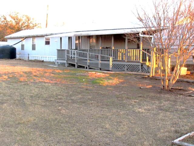 This 3-bedroom, 2-bath home is ideal for anyone seeking space, storage, and a large lot.
-  Four Lots Totaling 0.688 Acres offers plenty of room for outdoor activities, gardening, and expansion.
-  Multiple Covered Decks enable you to enjoy outdoor living and entertaining on both the front and back of the home.
-  Workshop and Garages.  An extra-large workshop, a separate 2-car garage, and a lawn equipment shed provide exceptional storage and project space.
-  Multiple Roll-Up Doors make easy access for vehicles, equipment, and materials.
-  Updated HVAC System (outside unit was replaced in 2021).
-  Metal Roof provides long-lasting durability and protection.
-  Rainwater Collection Systems which includes gutters and multiple storage tanks for sustainable gardening.
-  Greenhouse and Multiple Out-Buildings and Sheds. Perfect for hobbyists, gardeners, and those needing extra space for equipment, tools, and supplies.
-  3-Car Carport offers plenty of covered parking for vehicles.
-  Appliances, Shop Equipment, and Lawn & Garden Equipment will convey.