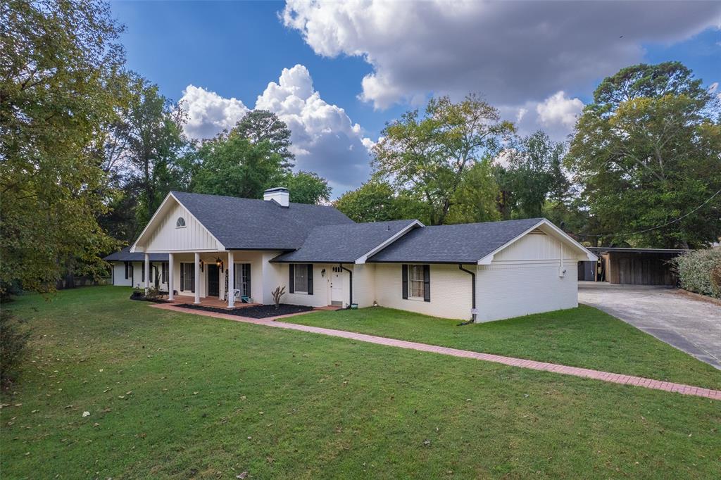 Welcome to 1010 S. Williams Avenue, an exceptional feature home in the prestigious Dellwood Park area of Mt. Pleasant. Set on more than two beautifully manicured acres, this property is graced by magnificent mature oaks that create a sense of privacy, elegance, and timeless East Texas charm. With 5 bedrooms and 4 full bathrooms, plus an upstairs bonus space offering endless possibilities for a media room, private office, or guest retreat, this home was designed for both comfort and versatility.

The kitchen is a true chef’s workspace, thoughtfully laid out for entertaining and everyday living. The classic brick flooring throughout the main living areas adds warmth, character, and enduring style that never goes out of fashion. Step outside to a fully fenced backyard shaded by towering oaks, complete with a dedicated dog run and generous outdoor space ideal for relaxing or hosting on warm summer evenings.

The property also features two shop or storage buildings, along with a newly constructed gym or work area, offering rare flexibility for hobbies, fitness, or additional workspace. Ideally located near schools and churches, and just seven minutes from the award-winning Titus County Regional Hospital, this home blends luxury, livability, and location. Thoughtfully built, impeccably maintained, and increasingly hard to find, this is a home that stands apart in every way.