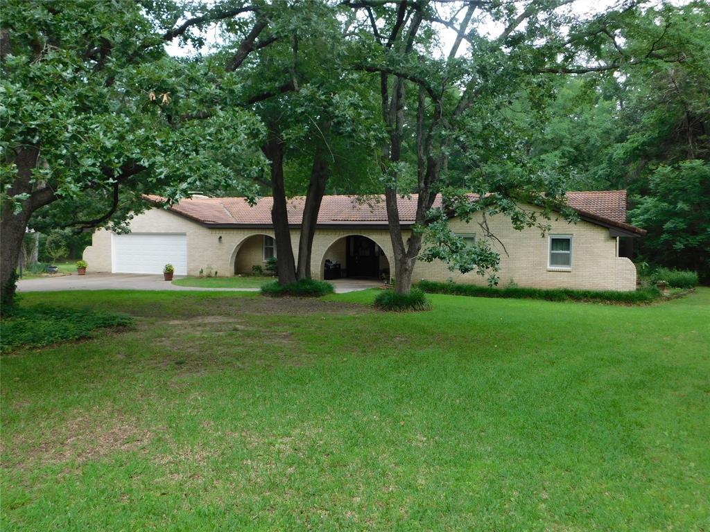 Come to the privacy and seclusion.  You will find a wonderful 6 ac, 3 bedroom, 2 bath, 2315 sf, with a 2 car garage, a garage door opener in the main house. Inside the front door you will find a Room that could be a formal living room or could be a wonderful office. Overall, you will see some new custom flooring, new paint, tile floor and carpet. The Kitchen has wood-stained cabinets, great counter tops, stainless steel appliances, walk in pantry, a mobile custom island, all electric appliances & a double oven for lots of baking.  The Den has a stove type wood burning fireplace & a sliding glass door to one of two patio's. The guest bathroom has double sinks & new tile flooring. The Primary bathroom has new paint, walk in closet, separate shower, tub & a sink. The utility room has a sink, cabinets & a counter to wash and fold your clothes as needed. A custom separate 30x40 metal building-shop with a 20’ deep covered concrete carport. The inside has electrical to work with, insulation, concrete floor, LED lighting,1 roll up door & a walk in door. This property has a new 11’ x 20’ concrete patio, ½ acre garden w sandy loam soil w a 55 ft deep well for extra water. The road is asphalt with asphalt and gravel in the driveway. There is also an abundance of wildlife in this area, many deer and small animals.  There is only a half of acre to be mowed on this secluded property. This property is 3.5 miles to McDonald's and 4 miles to Walmart. There are many restaurant's, church's & fast food eating in Bonham to enjoy.   Call Broker Bay for an appointment to see this secluded & quiet property. Your offer will be considered.
