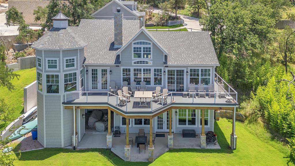 Nestled along the tranquil shores of the lake, this stunning 5-bedroom, 5 full and 2 half-bath estate offers the perfect blend of luxury, comfort, and breathtaking views. The open-concept main living area seamlessly connects the living room, dining space, and gourmet kitchen, all framed by expansive windows that showcase panoramic lake vistas. Step outside onto the large upper or lower decks—ideal for entertaining or simply
soaking in the serene surroundings. The spacious master suite is a true retreat, featuring a cozy seating area, private patio
access, and sweeping lake views. The ensuite bath boasts a large walk-in shower and elegant finishes. Two additional bedrooms on the main level each offer private ensuites, ensuring comfort and privacy for family or guests. Downstairs, a massive game and family room awaits, complete with a second kitchen and direct access to multiple patio areas that lead to an open lawn and your private dock—perfect for lakeside living. Adding to the appeal is a separate guest house, thoughtfully designed with two bunkrooms, each with its own full ensuite, and a versatile third room that can serve as a sleeping area, game room, or den. The guest house also includes a convenient coffee bar and beverage fridge, making it a self-contained haven for visitors. With abundant storage throughout and every detail designed for both relaxation and entertaining, this lakefront gem is a rare opportunity to own a piece of paradise.
