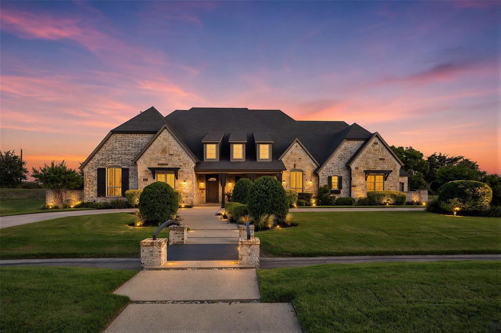 Situated on a gorgeous 1.5-acre homesite, this J. Anthony model home is equipped with luxury amenities throughout. Nestled among meticulously manicured grounds and a moat-style entry with a circle drive adds a unique touch. This home seamlessly blends timeless architecture with modern sophistication, featuring designer lighting, beamed and wood plank ceilings, and advanced smart home technology. Enjoy impressive 20-foot pocket glass sliding doors and a remote-controlled full-length patio screen, creating a perfect transition to the outdoor heated pool and infinity edge spa. The entertainer's kitchen boasts Thermador appliances and a built-in refrigerator, ideal for culinary enthusiasts and gatherings. The estate offers five spacious bedrooms, each with en-suite bath access and walk-in closets, providing comfort and privacy for all residents. Work from home in a dedicated office space with custom built-in cabinets and a stylish barn door.  An oversized six-car garage accommodates multiple vehicles with ease, while the fully equipped media room and game room offer entertainment and leisure options. The owner's suite is a true retreat, featuring custom wall paneling and vaulted ceiling, a walk-in shower with body sprayers, and a free-standing tub. The basement features a state-of-the-art theater and a secret door leading to a safe room, ensuring both entertainment and security. The six-car garage includes one bay large enough to accommodate a boat or small RV, providing versatile storage and parking solutions. There is an unfinished attic with a full staircase, presenting the opportunity for completion as a third floor. For more information and tours, please visit the virtual tour link included in this listing.