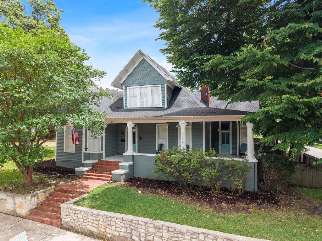 Own a true piece of Tyler history with this remarkable Queen Anne-style residence located in the highly sought-after Historic Brick Street District! Rich in character and architectural detail, this historically designated home beautifully blends timeless craftsmanship with thoughtful modern updates while preserving many of its original features, including hardwood floors, stained glass windows, intricate millwork, and multiple fireplaces throughout. A grand covered front porch framed by stately white columns welcomes you inside, where you'll immediately be captivated by the spacious living room anchored by an incredible carved marble fireplace. The primary suite offers a private retreat complete with its own fireplace and a charming en suite bath featuring a classic clawfoot soaking tub. A versatile parlor provides endless possibilities as a second living area, home office, library, or guest space. The gourmet kitchen is designed for both everyday living and entertaining, featuring stainless steel appliances, a gas cooktop, generous prep space, and seamless access to the stunning formal dining room that is sure to impress guests. A downstairs guest bedroom with an attached bath provides comfort and convenience for visitors. Upstairs, you'll find a spacious loft area ideal for a media room, playroom, or additional living space, along with bonus rooms that offer flexibility for hobbies, guests, or work-from-home needs. With 5 bedrooms and 2.5 baths, there is no shortage of space while still maintaining the home's historic charm and elegance. Outside, enjoy a spacious covered porch perfect for rocking chairs as well as open patio areas perfect for entertaining, relaxing, and taking in the beauty of this one-of-a-kind property. Opportunities like this are rare. Experience the craftsmanship, history, and character of one of Tyler's most treasured homes while enjoying the comforts of modern living in the heart of the Historic Brick Street District.