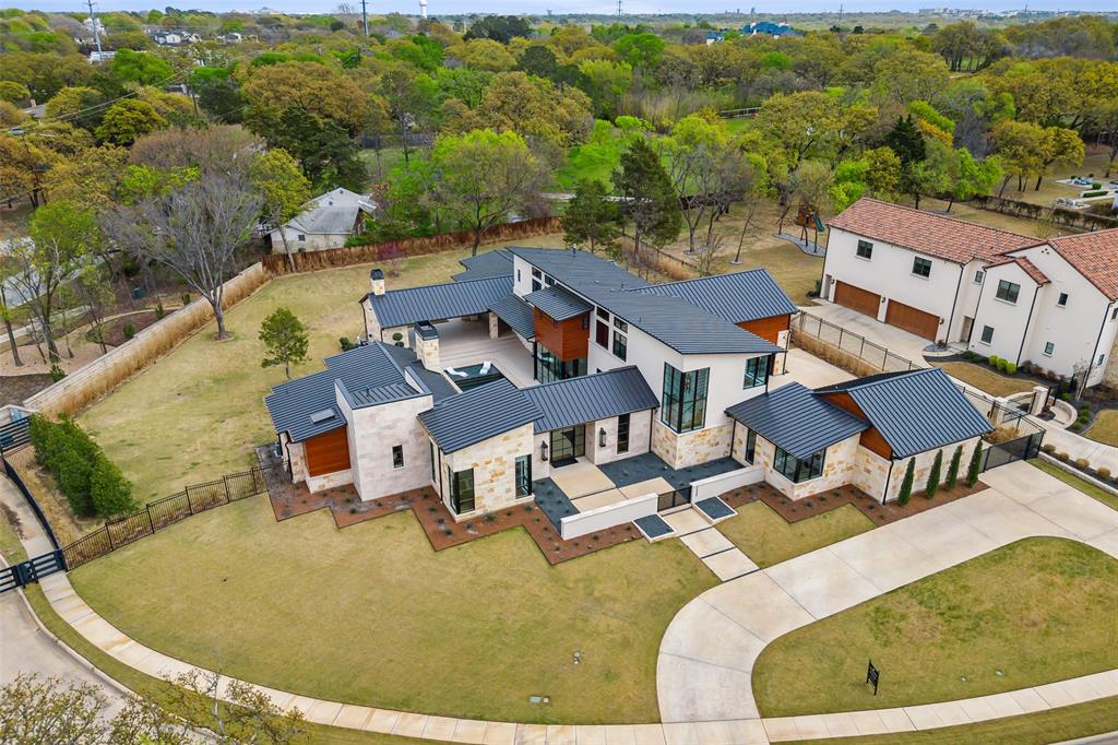 Modern masterpiece in the desirable Moss Farms of Southlake! Built by Atwood Custom Homes. Exceptional floorplan with versatile living spaces and an abundance of natural light throughout. Inviting entry, designer lighting and fixtures, and attention to every detail. The gourmet kitchen opens to the massive great room and is perfect for entertaining. Elegant formal dining room with adjacent wet bar with wine coolers. The dreamy master suite offers a wall of windows overlooking the property and a cozy fireplace. The luxurious master bath features a massive walk-in shower, elegant vanity, soaking tub, and dual custom closet. Recent addition of upstairs bonus room. Gorgeous outdoor living area with fireplace, built-in grill, and overlooking the sparking pool and spa for year-round enjoyment. Featuring a Savant home automation system. Spacious one-acre lot in a gated neighborhood. Easy access to DFW International Airport.