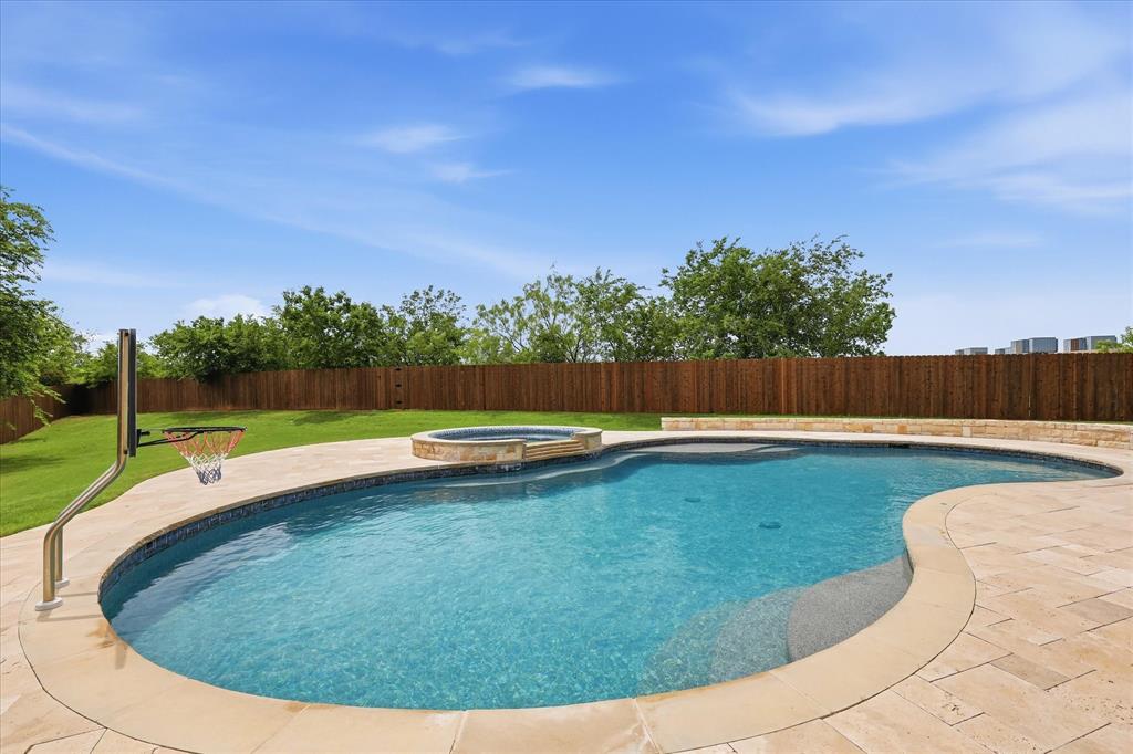 Amazing home in Keller ISD with pool on oversized lot!  Beautifully updated inside with wood floors, neutral decor, and very open layout!  Very light and bright with high ceilings!  Large eat-in-kitchen with quartz countertops, stainless steel appliances, large island and plenty of room to cook and entertain!  Spacious living room with cozy fireplace, overlooking your amazing backyard oasis!  Room for large family and large furniture!  Formal dining room or use as flex space.  Relax and unwind in the primary bedroom with French doors that open to the pool!  Huge closet and spa-like retreat!  Dual sinks with quartz countertops, shower and tub!  Great storage and good sized laundry room!  Remodeled baths! Upstairs enjoy a HUGE game room, 5 more fantastic bedrooms and 2 full baths!  Use 6th bedroom as flex space, home gym, or office! So much room and so many possibilities!  Step into your dream backyard oasis!  A sparkling oversized Claffey pool with hot tub and travertine decking!  Outdoor kitchen to BBQ for your friends and family!  Wonderful outdoor covered patio too!  The yard is one of the largest around at just under a half acre!  3 car garage!  Close to the schools, entertainment, HEB, shopping, Alliance Town Center, and Highway 35!  Run to see this impeccably maintained home! Newer: roof, gutters hvac, tankless water heater, fence, driveway, and more!