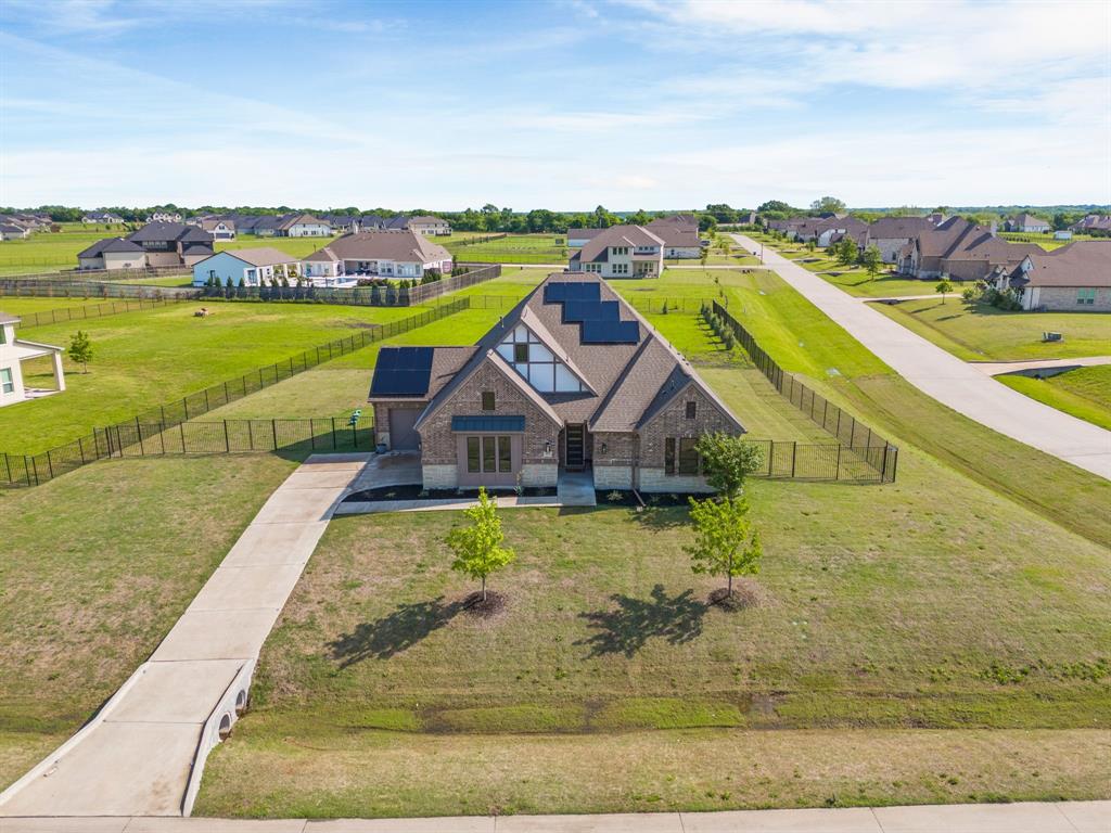 Experience modern luxury in this impeccably maintained GFO Home! This stunning residence boasts soaring cathedral ceilings, an inviting gas fireplace in the main living area, and an expansive culinary kitchen equipped with stainless steel appliances, soft-close drawers, an extended island, and a dedicated dining area. Huge sliding glass doors seamlessly connect the indoor space to an extended, enclosed, covered patio, perfect for entertaining.

The current owners have thoughtfully enhanced the property with upgraded landscaping, creating exceptional curb appeal and inviting outdoor living spaces. A beautiful sunroom addition provides the perfect place to relax and enjoy year-round natural light, while fully installed solar panels convey with the property at no additional cost, offering valuable energy efficiency and long-term savings.

The luxury primary retreat features a custom walk-in closet, an elegant free-standing tub, and a frameless glass shower. Spacious secondary bedrooms are situated off the second living area, providing privacy and comfort. A private office can also function as a fourth bedroom.

Premium designer finishes flow throughout the home, including epoxy flooring in the three-car garage. Zoned to McKinney ISD, this exceptional property is set on a rare acre in the prestigious Highland Park peninsula of Lavon Lake. Enjoy the serenity of nature with nearby equestrian and walking trails, plus a convenient boat launch just minutes away.

Escape the feel of the big city and experience the perfect blend of luxury, efficiency, and tranquility. Schedule your private tour today!