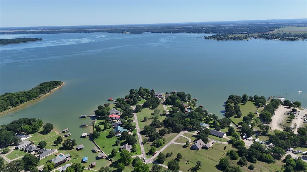 Tucked away in the small, cozy community of Paradise Bay, this half-acre corner lot is the kind of property that makes you slow down, breathe deep, and start dreaming about lake life. Surrounded by mature trees and offering beautiful lake views, this is an incredible opportunity to build the custom home you’ve always wanted near the shores of Richland Chambers Lake. With over 500 feet of road frontage, you’ll have plenty of flexibility for your homesite design, extra parking, outdoor living spaces, or even that dream workshop you’ve been wanting.

Paradise Bay is a quiet site-built homes subdivision with a minimum build requirement of 1,500 square feet, helping preserve the peaceful charm and quality of the neighborhood without the restrictions of an HOA. Whether your perfect day includes fishing at sunrise, boating with friends, relaxing by the water, or simply enjoying the beauty of nature, this location puts you close to it all. You’ll also love being near the central portion of the lake, giving you quick access to popular lakefront restaurants, marinas, and convenient small markets nearby.

If you’ve been searching for the perfect blend of peaceful lake living, convenience, and room to create your own private getaway, this property checks all the boxes. Opportunities like this don’t come around often—come see what makes Paradise Bay such a special place to call home.