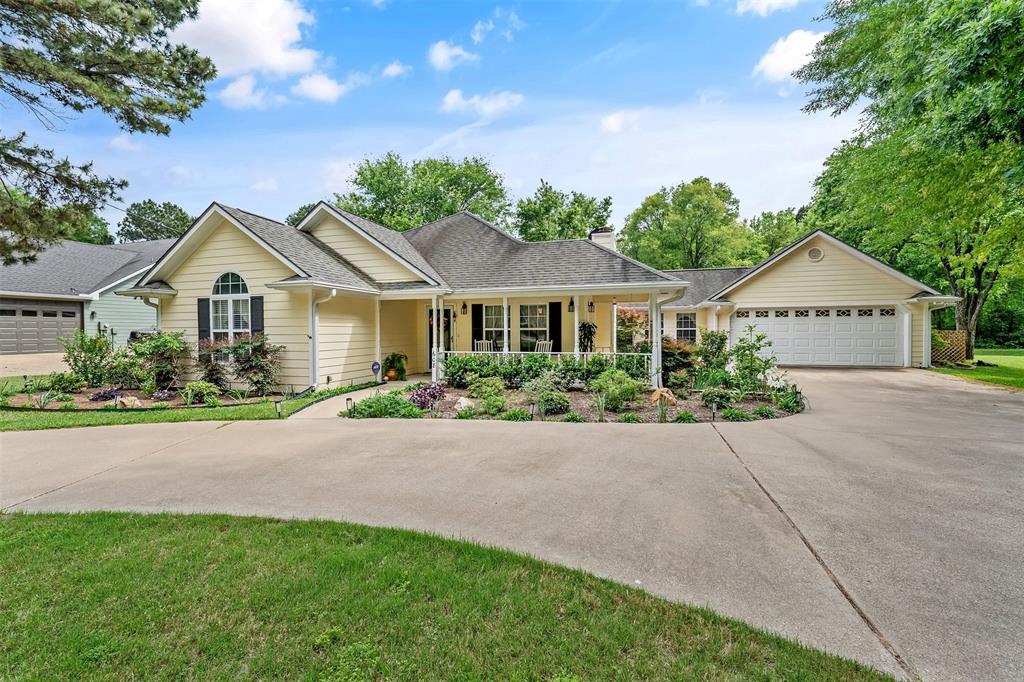 Beautiful Holly Lake Ranch home! This 3 bedroom, 2 bath home features two living areas and an open concept layout full of character and crown molding throughout. Living room offers a cozy WBFP fireplace, but has electric logs too! Kitchen includes granite countertops, tile backsplash, double ovens, breakfast bar, pantry, and appliance garage. Spacious primary suite with jetted tub, double lavatories, separate shower, and walk in closet. The two guest rooms are spacious as well! Large utility room with extra pantry and space for freezer. Enjoy the wraparound front porch, screened in back porch, open deck, storage building, and fenced private backyard. 50-amp RV hookup. This amazing home has great curb appeal, established flowerbeds, sprinkler system, and circular concrete drive. This property also has an additional lot! Immaculate and move in ready. Call and come see today!!