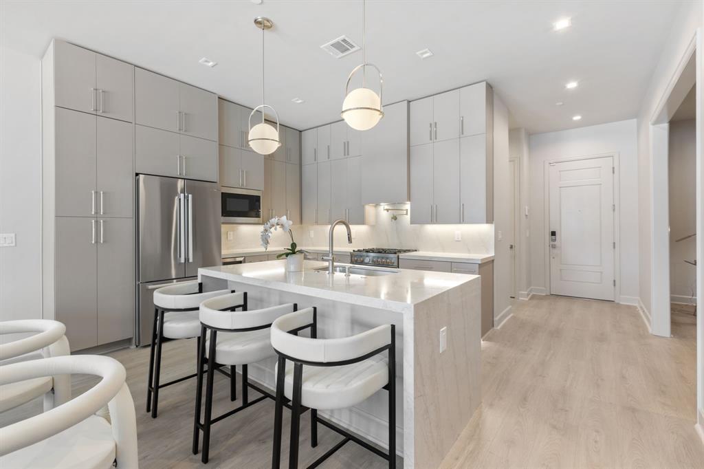 *Ask about Buyer Incentives, including a 2-1 buydown with the Preferred Lender!* Welcome to Unit 509 at The Ruston, a newly completed new-construction residence offering panoramic Downtown Dallas skyline views and refined modern living on the edge of the city’s urban core. This exclusive condominium building sets the standard for sophisticated living, combining striking architecture with world-class amenities in the heart of the vibrant Cedars neighborhood, just minutes from premier dining, shopping, entertainment, and cultural attractions. This architectural masterpiece features 58 luxury condominium residences, each meticulously crafted with premium materials and thoughtful design Residents enjoy access to a full suite of resort-style amenities, including a community reflection pool, state-of-the-art fitness center, media room, wine room, game room, clubhouse, conference room, dog run with dog-washing station, pickleball court, putting green, and an outdoor lounge with grilling areas, ideal for entertaining or unwinding in style. Unit 509 offers 1,133 square feet, featuring 1 bedroom + 1.5 bathroom and an oversized office space. The open-concept interior showcases high ceilings, designer fixtures, and upscale finishes, highlighted by a chef’s kitchen with a 6-burner Bertazzoni gas range, Bosch refrigerator, wine cooler, pot filler, under-cabinet lighting, and soft-close cabinetry. Built-in surround sound speakers, an electric fireplace, and private balcony enhance both comfort and functionality.